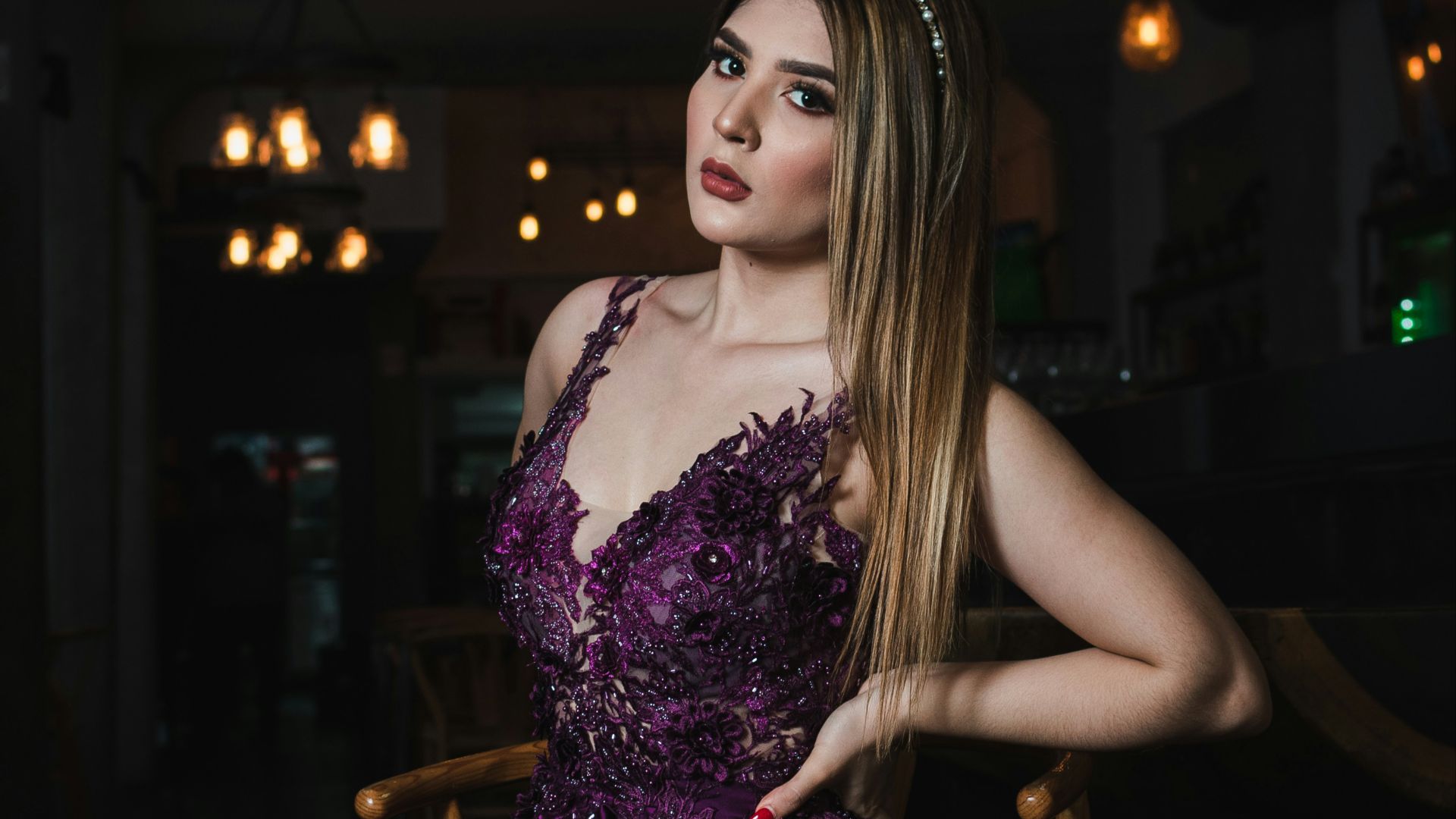 Woman in a purple gown sitting in a chair