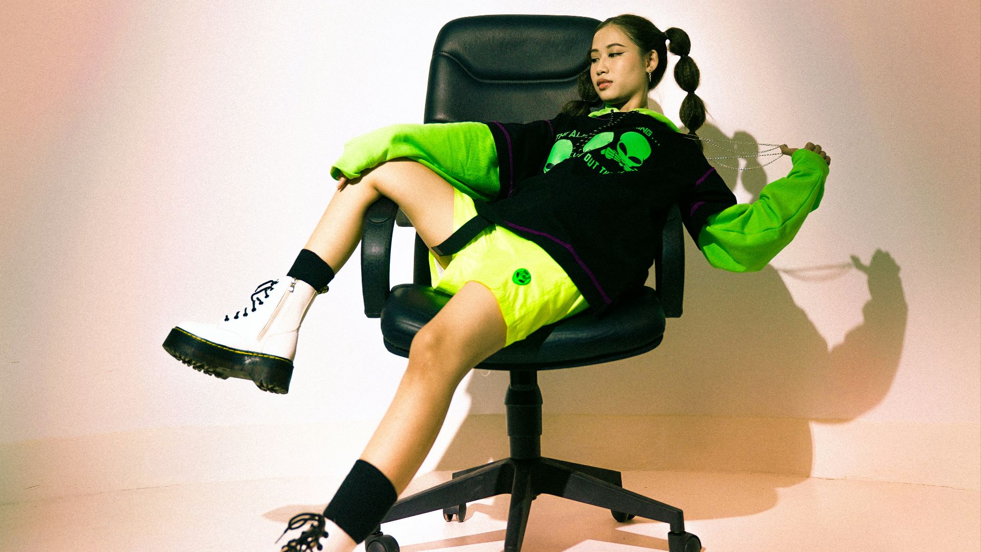 man in green and black jacket sitting on black office rolling chair