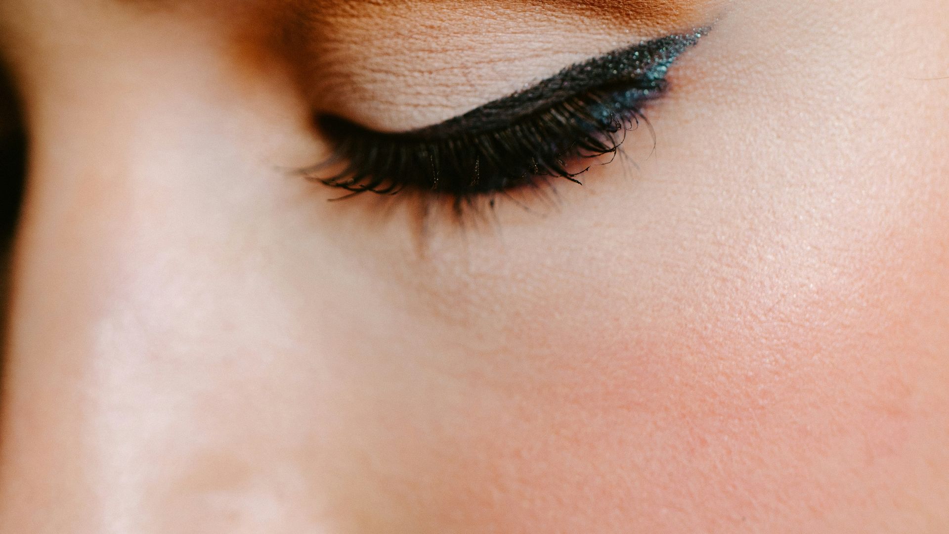 woman with red lipstick and black mascara