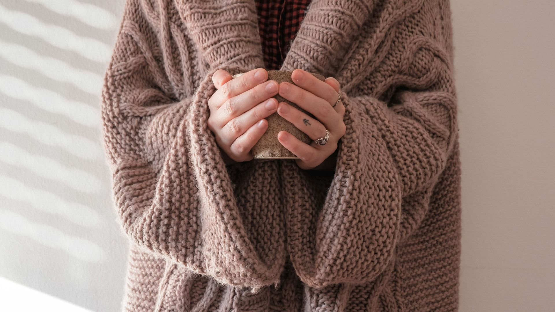 person in brown knit sweater