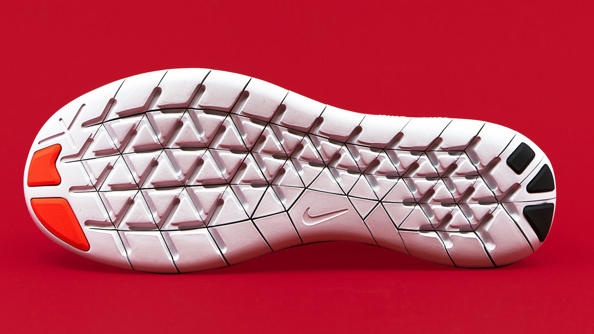 white, black, and red shoe sole