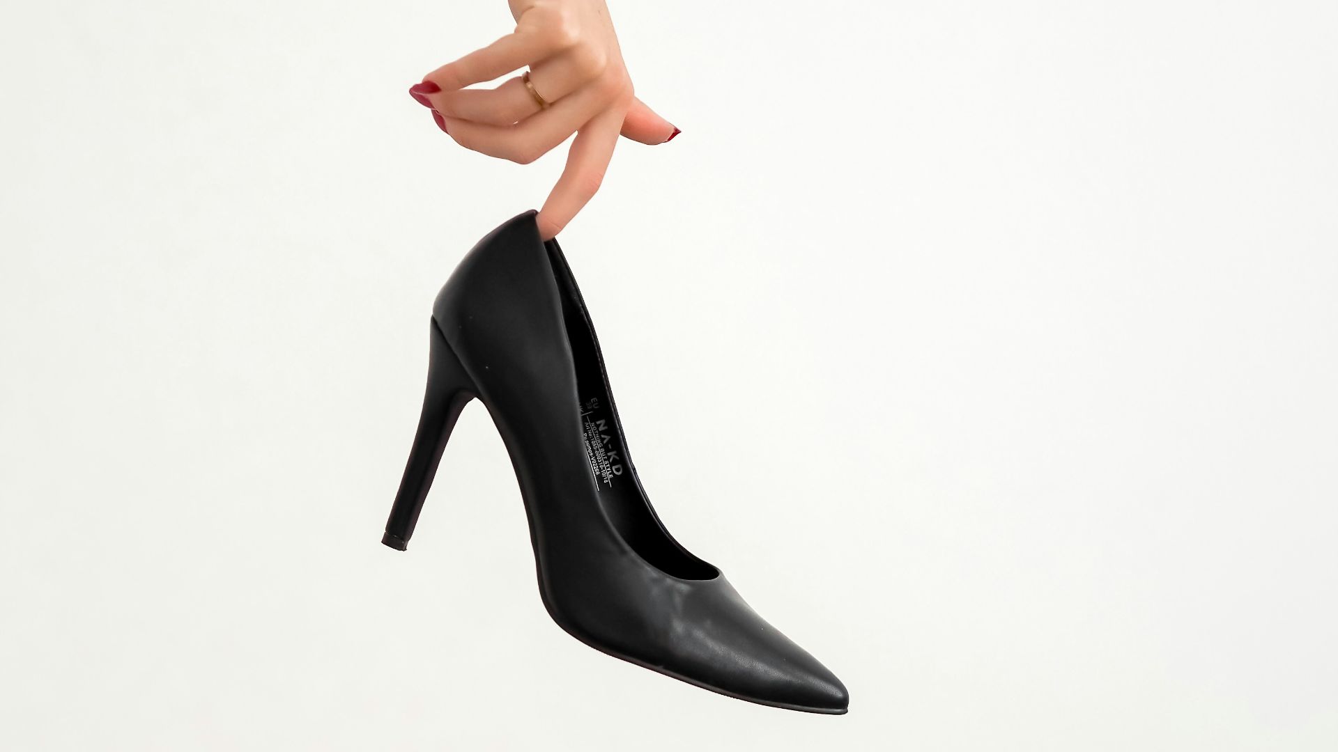 woman in black leather heeled shoes