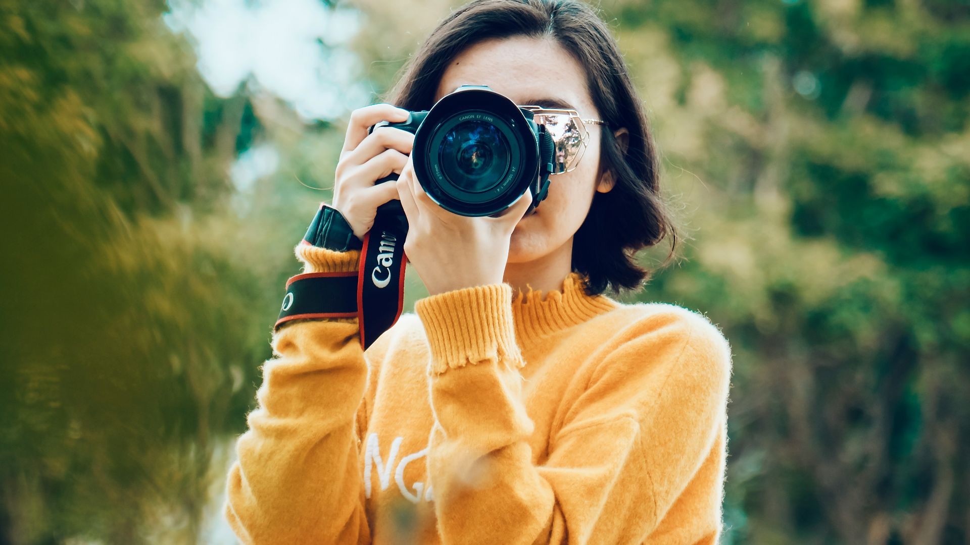 woman holding DSLR camera