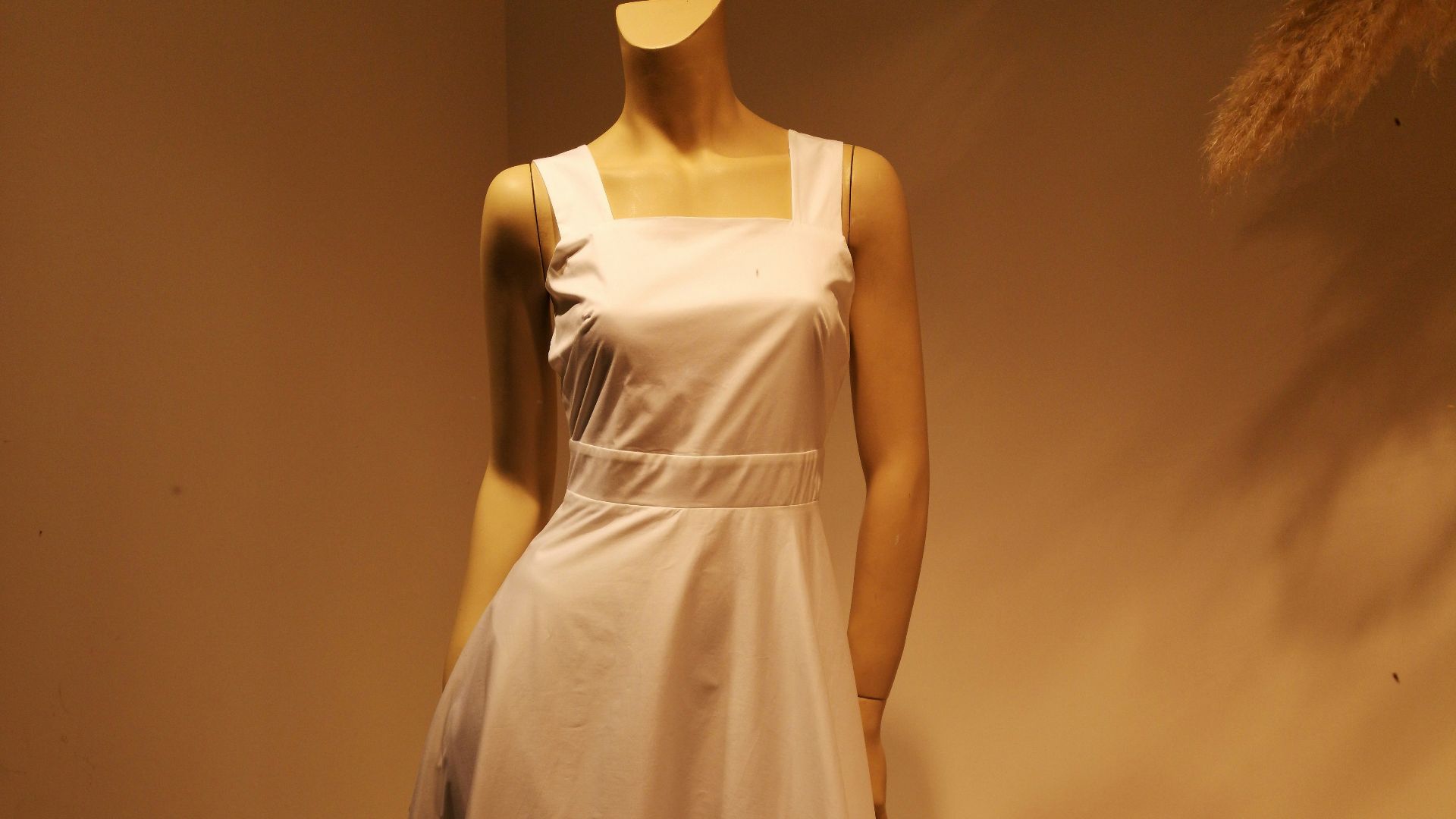 woman in white sleeveless dress