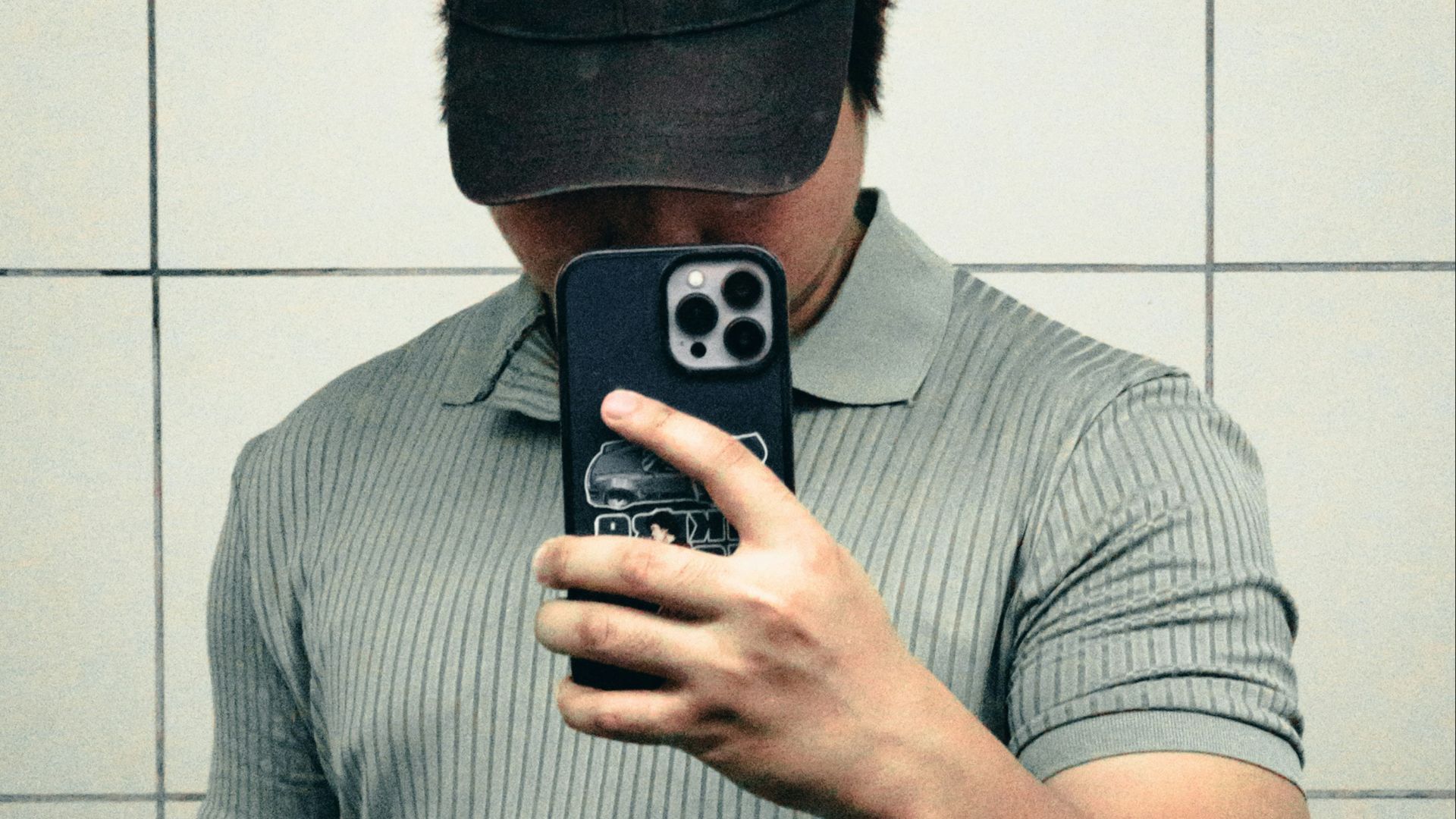 A man taking a selfie in a bathroom mirror