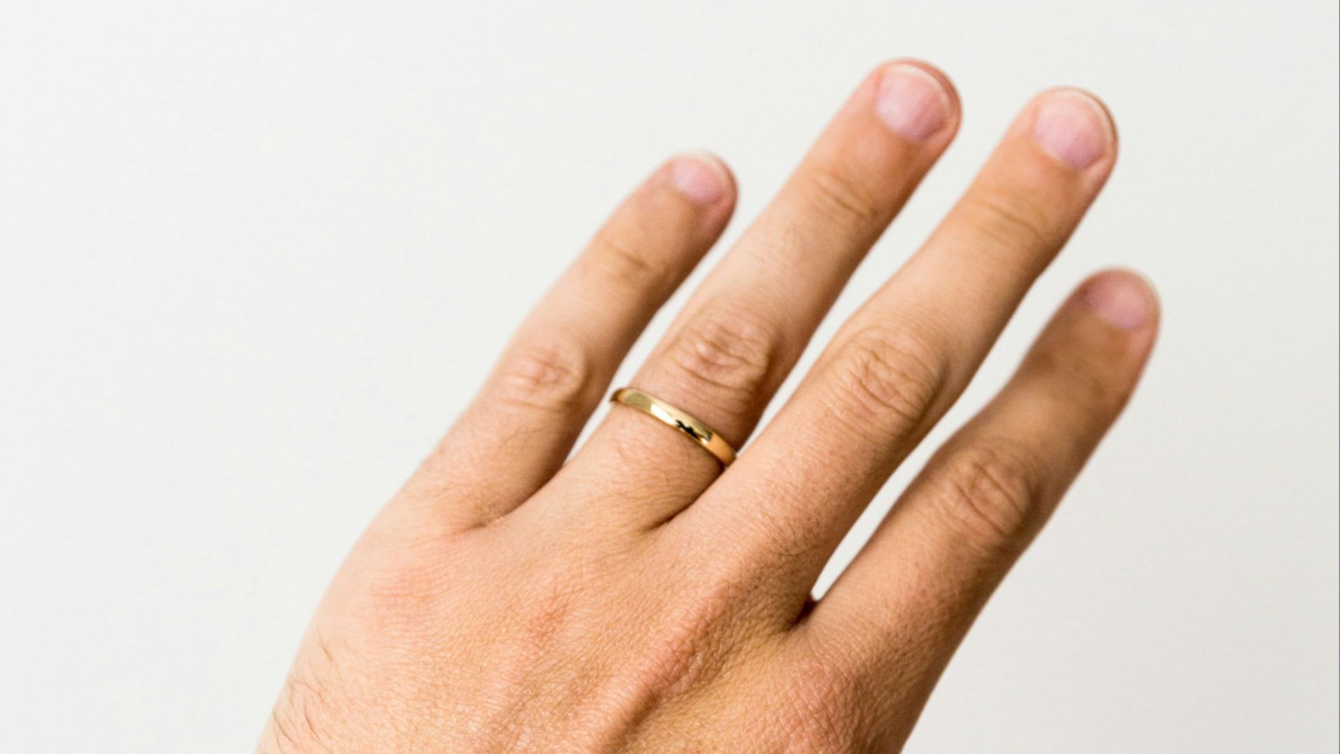 person showing gold-colored ring