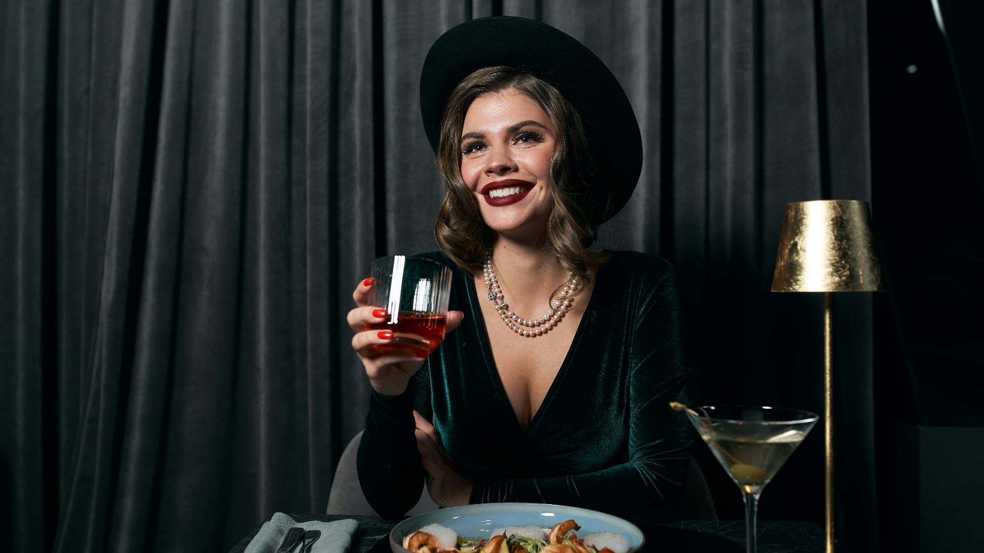 woman in black long sleeve shirt holding wine glass