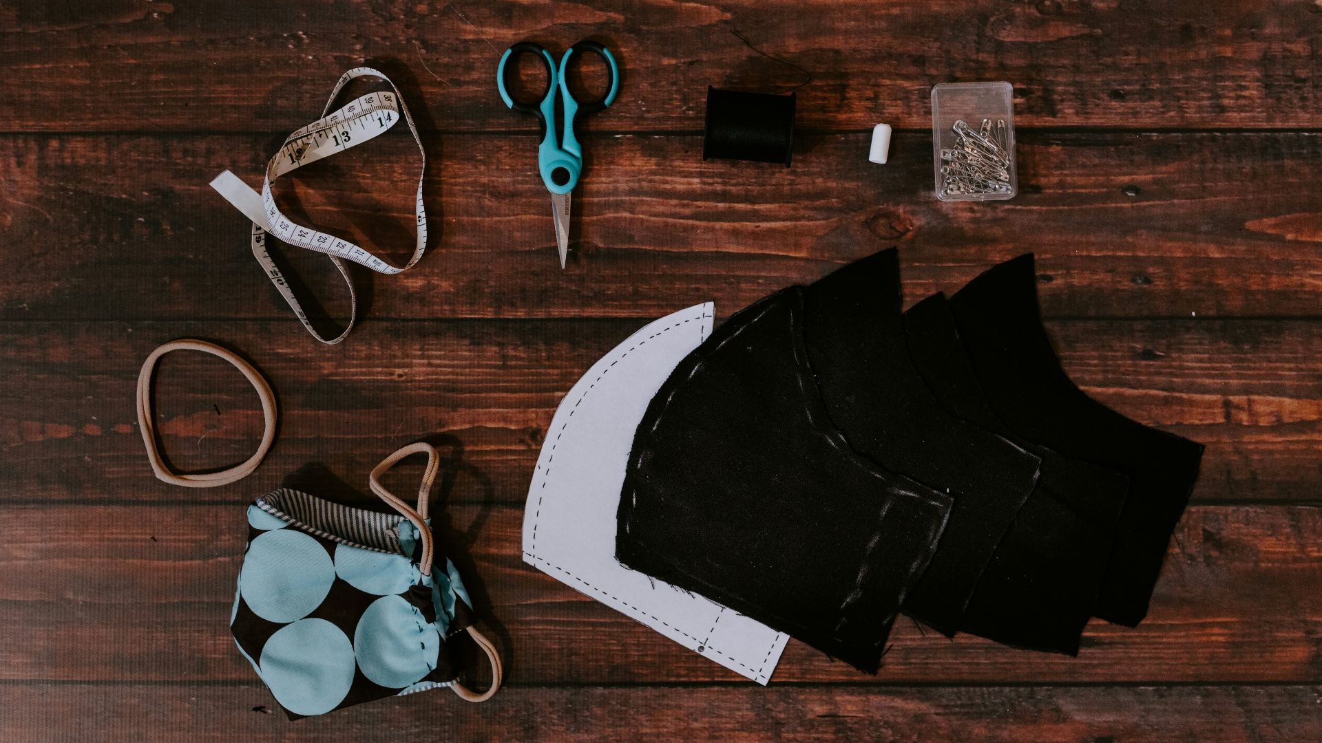 black and gray scissors beside black leather bag