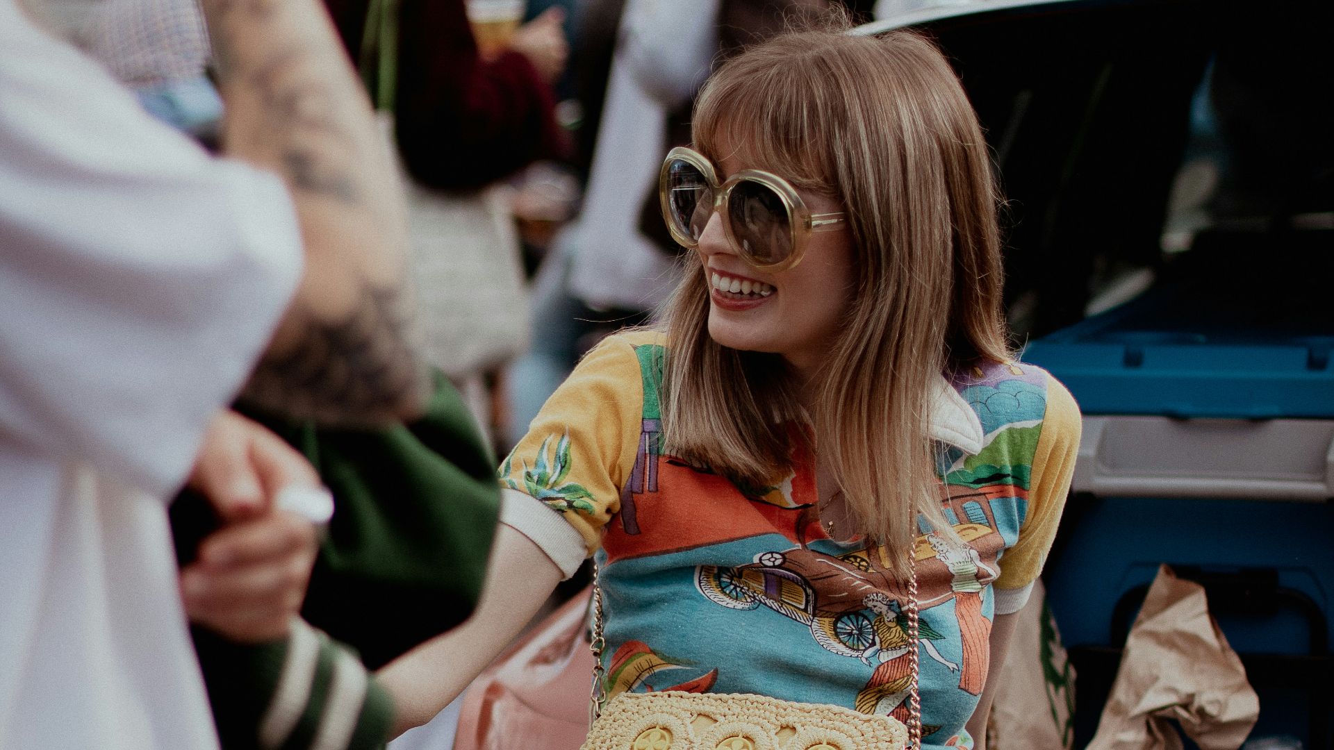 a woman sitting on the back of a car