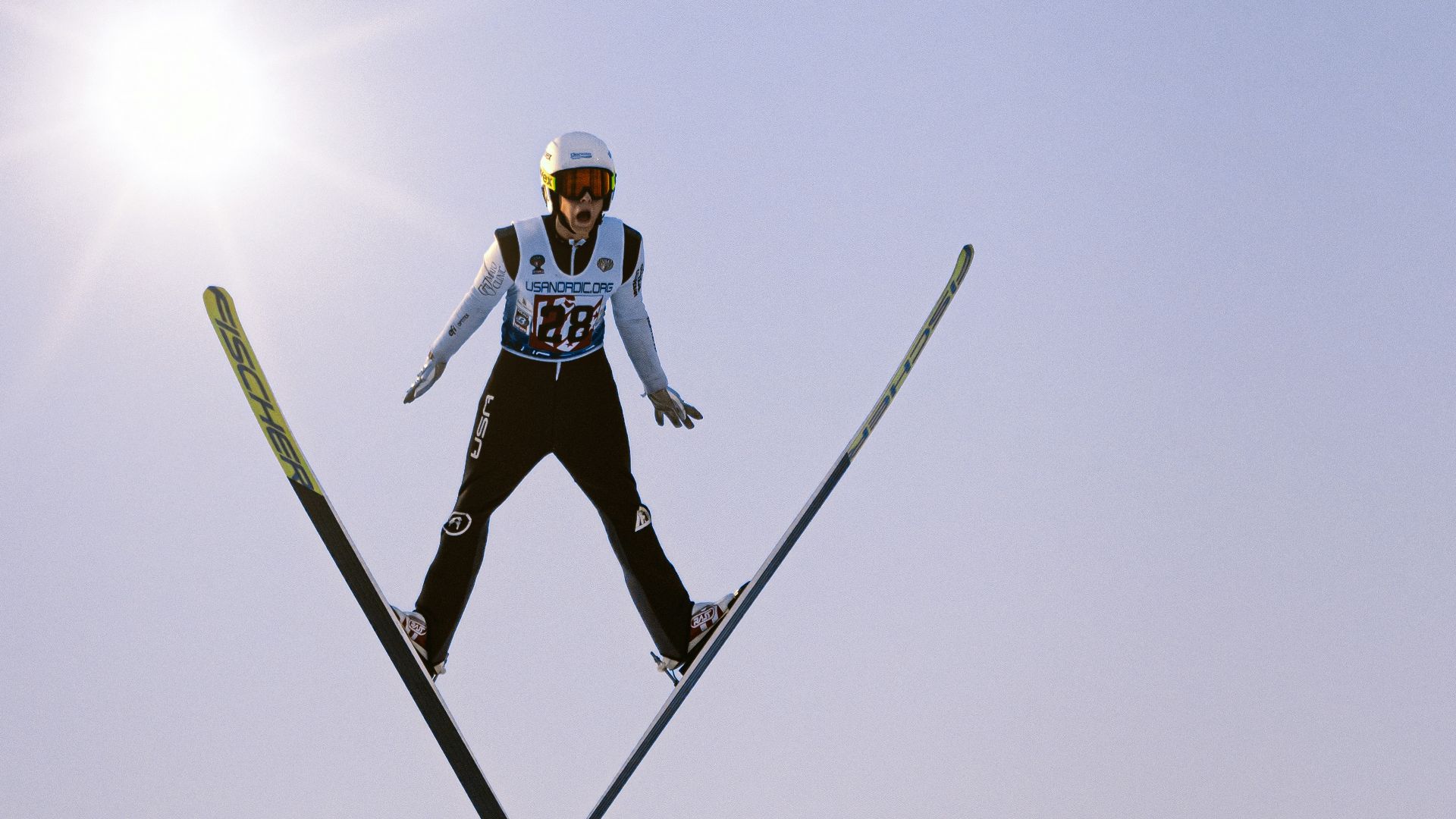 a man flying through the air while riding skis