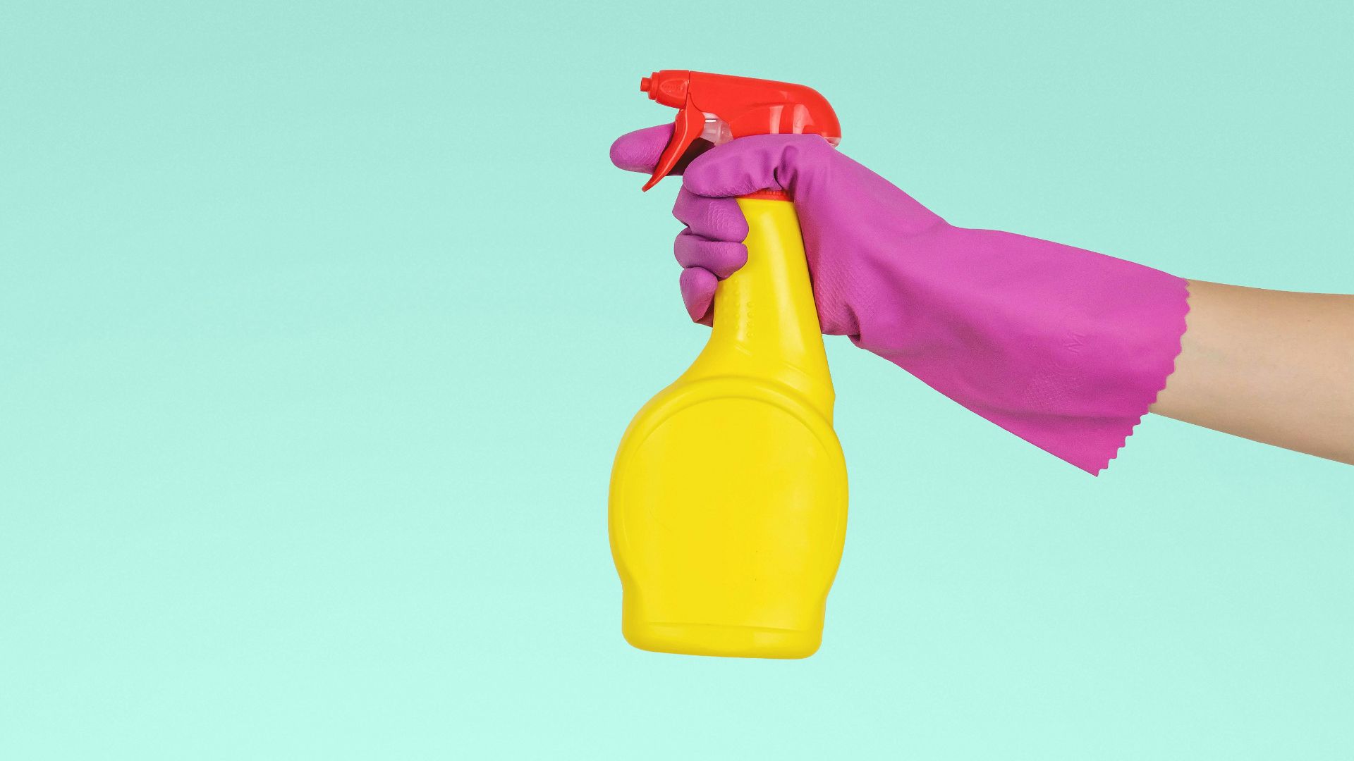 person holding yellow plastic spray bottle