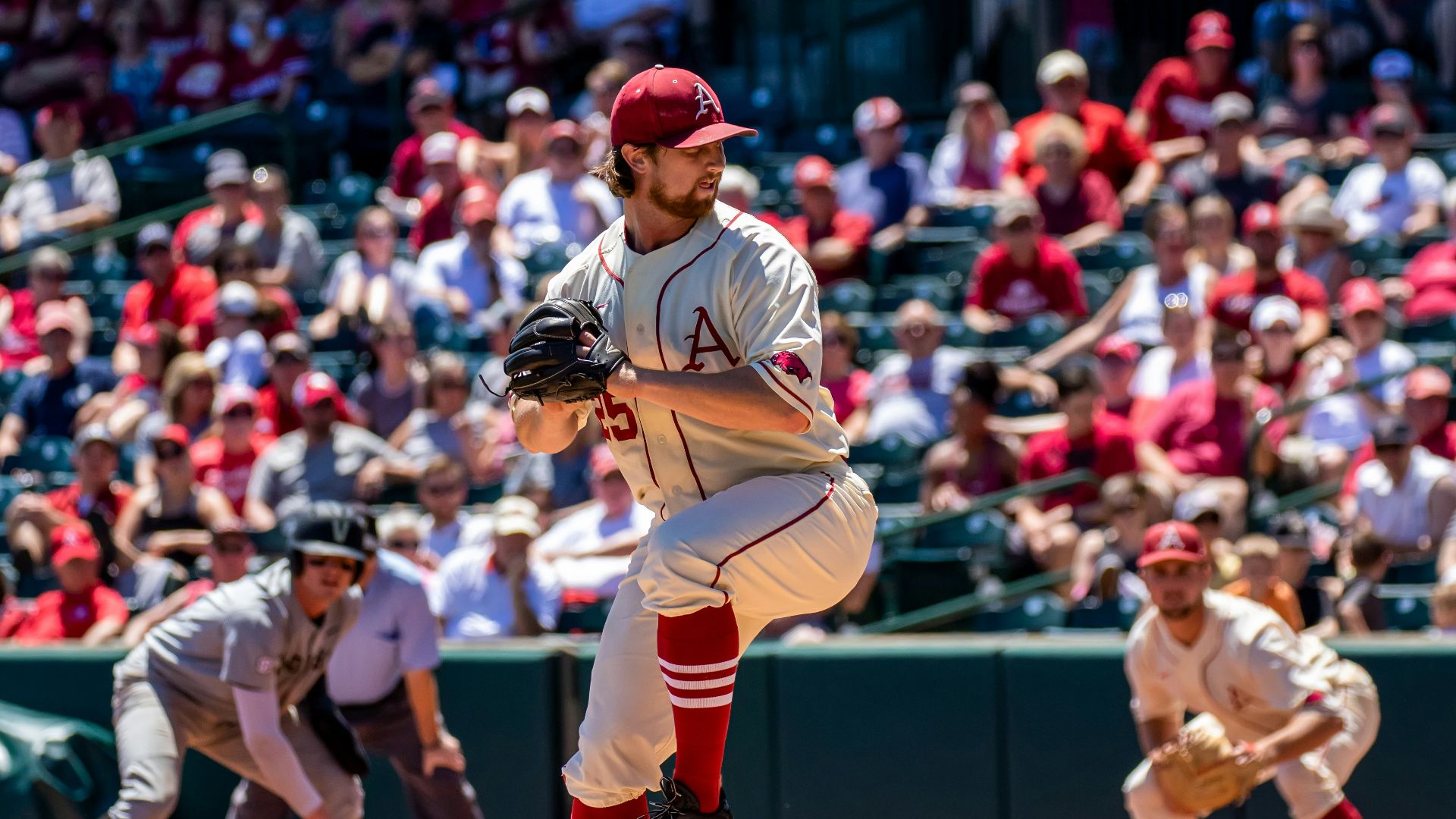 man in white and black baseball jersey shirt and red baseball cap
