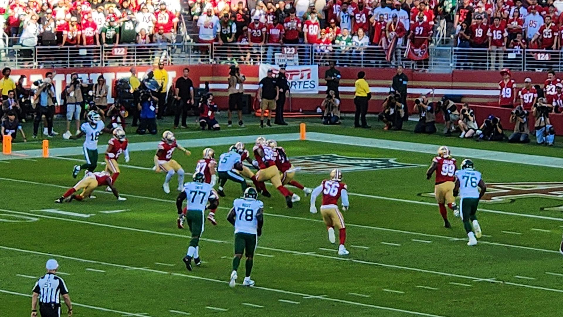 A football game is being played in a stadium