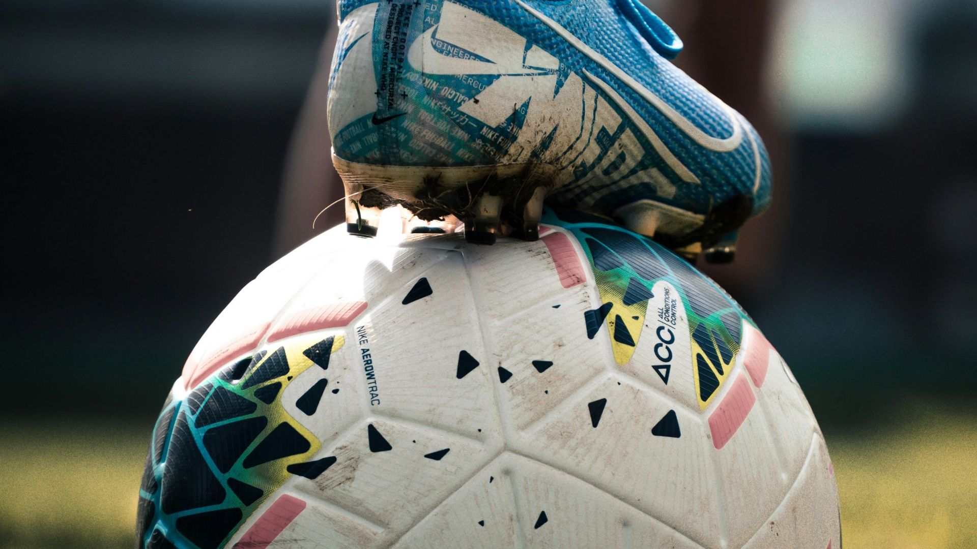 white and blue soccer ball on green grass field