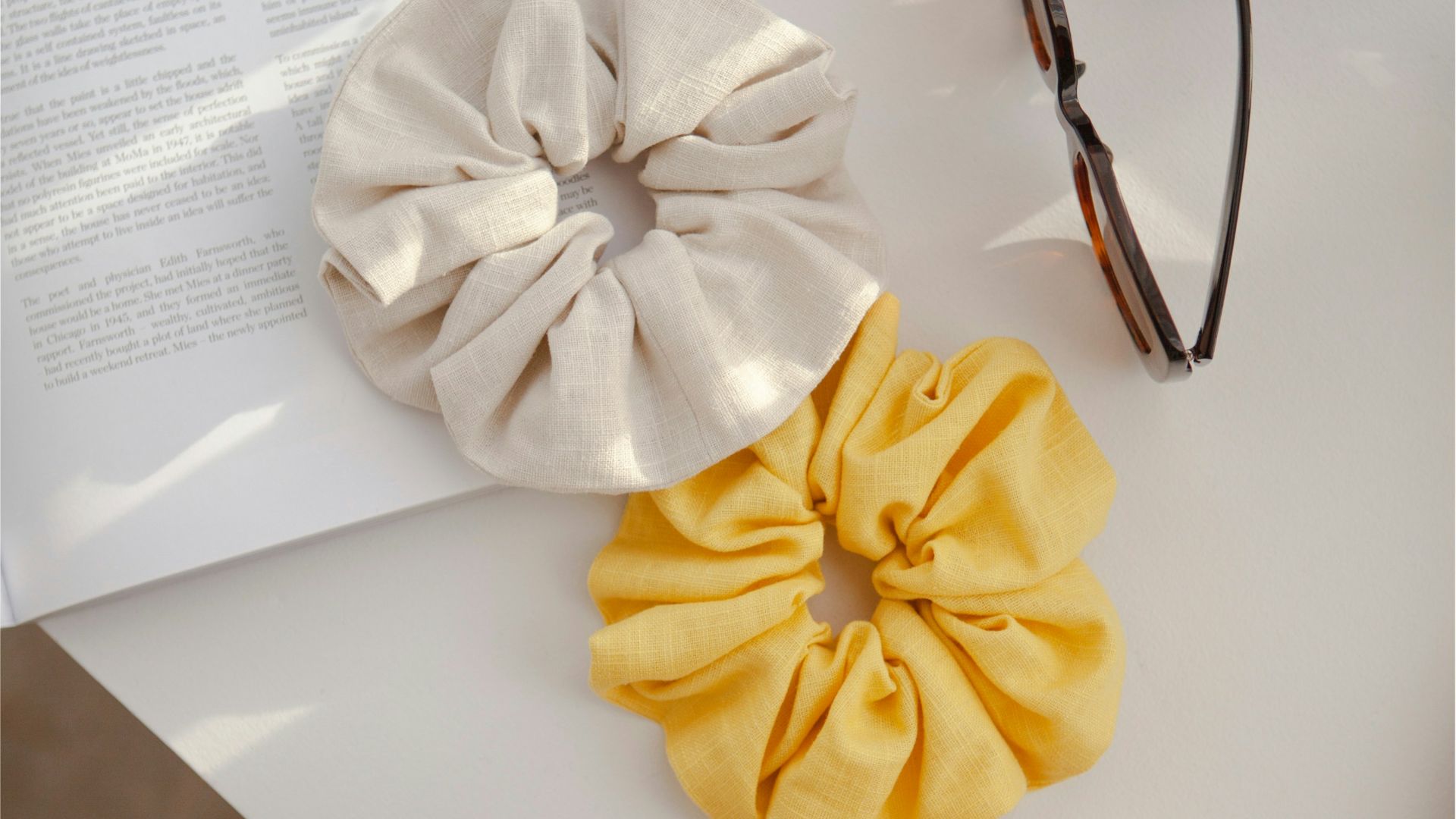 a pair of glasses and a hair scrunch on a table