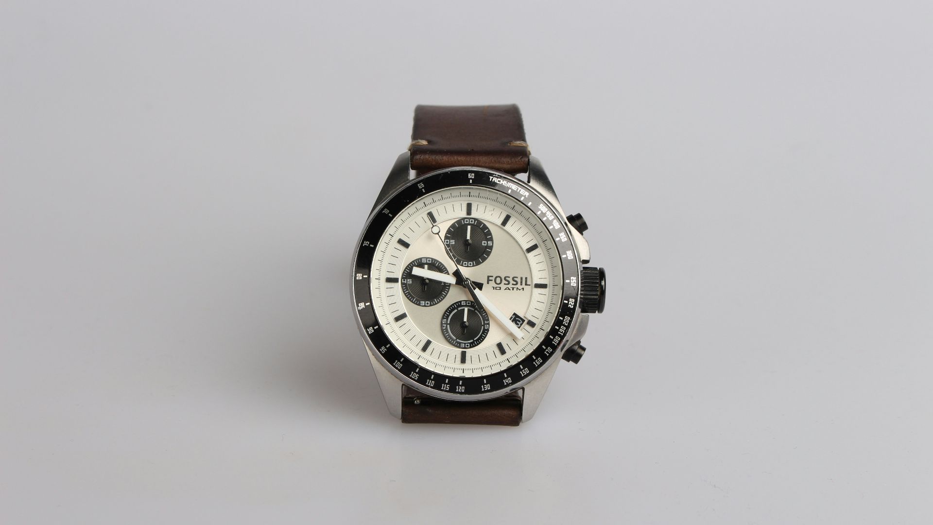 round silver-colored Fossil chronograph watch at 9:22 with brown leather band