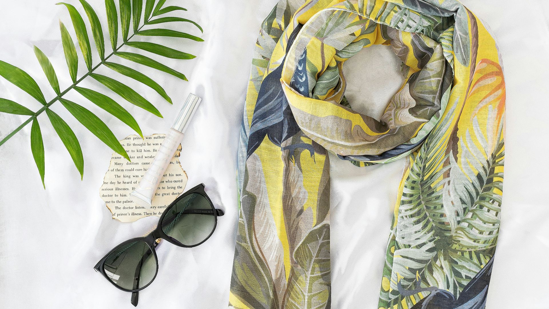 black sunglasses on yellow and white textile