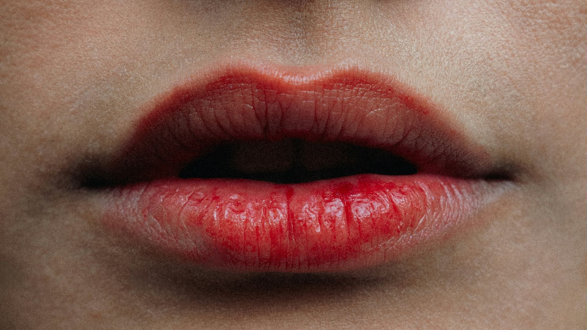 Close-up of a woman's red lips and nose
