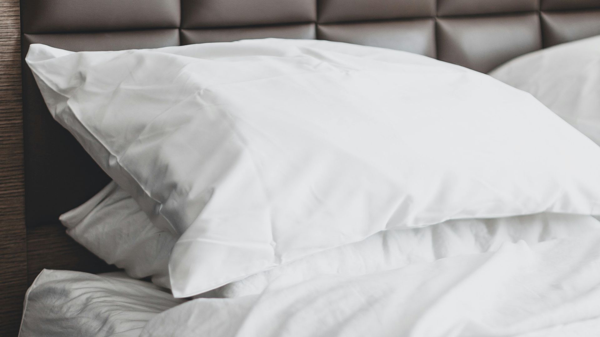 white bed pillow on bed