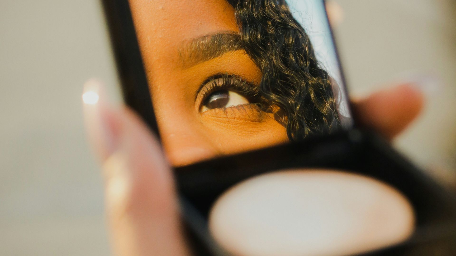 a woman holding a compact compact compact compact compact compact compact compact compact compact compact compact