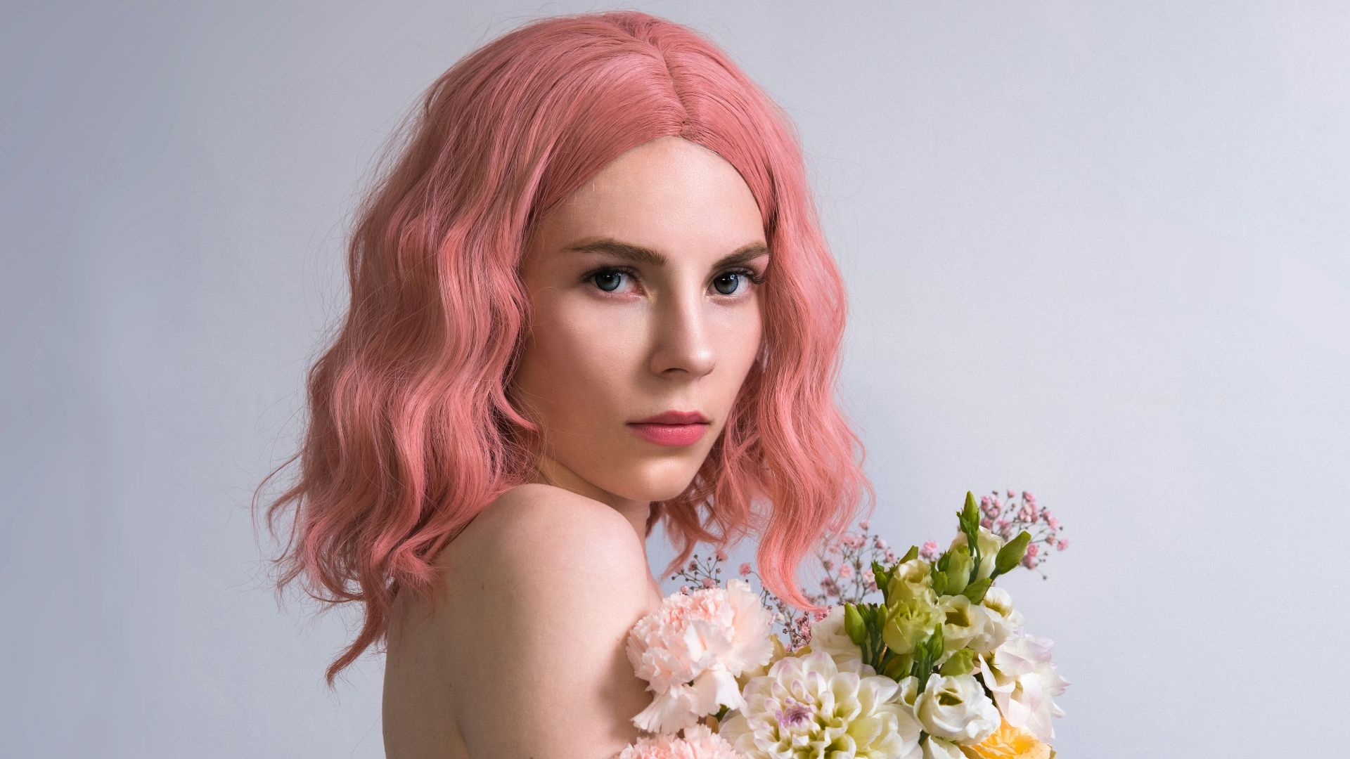 woman holding white and yellow flowers