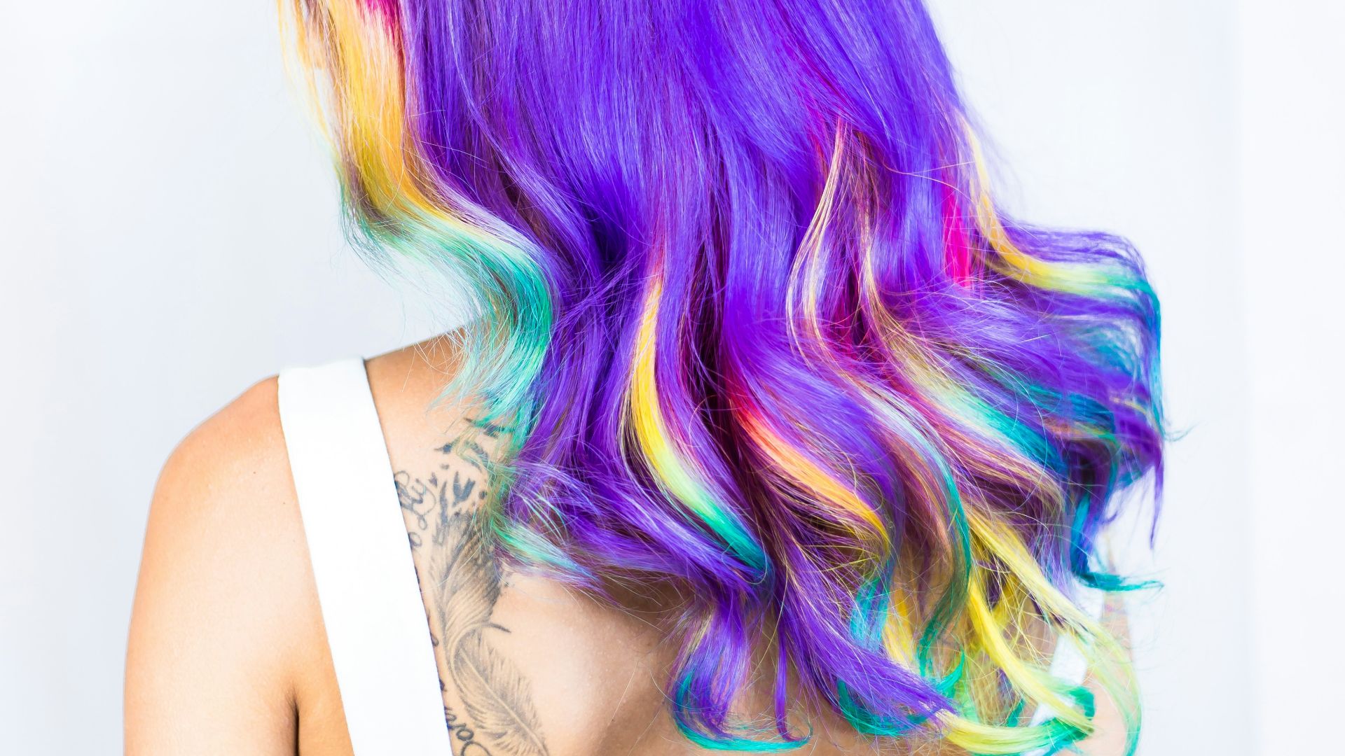 woman in white top with multicolored hairstyle