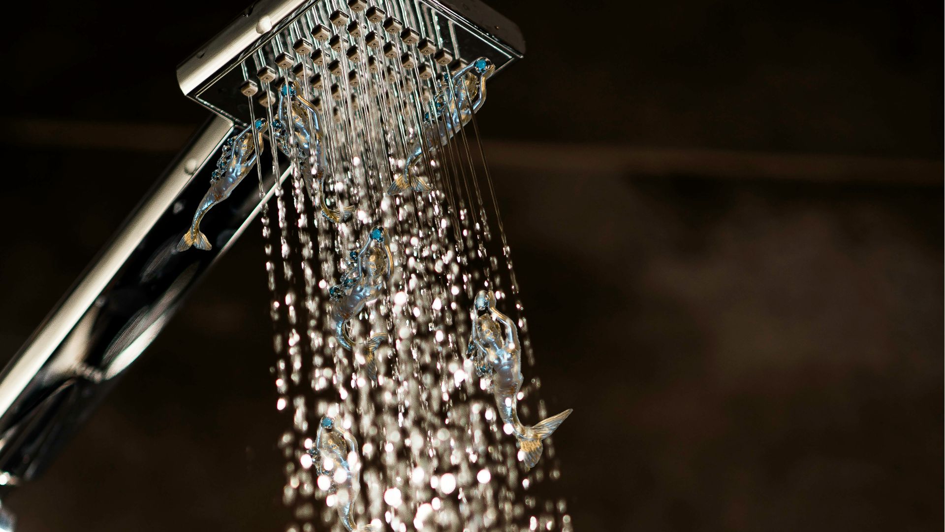a close up of a shower head with water coming out of it