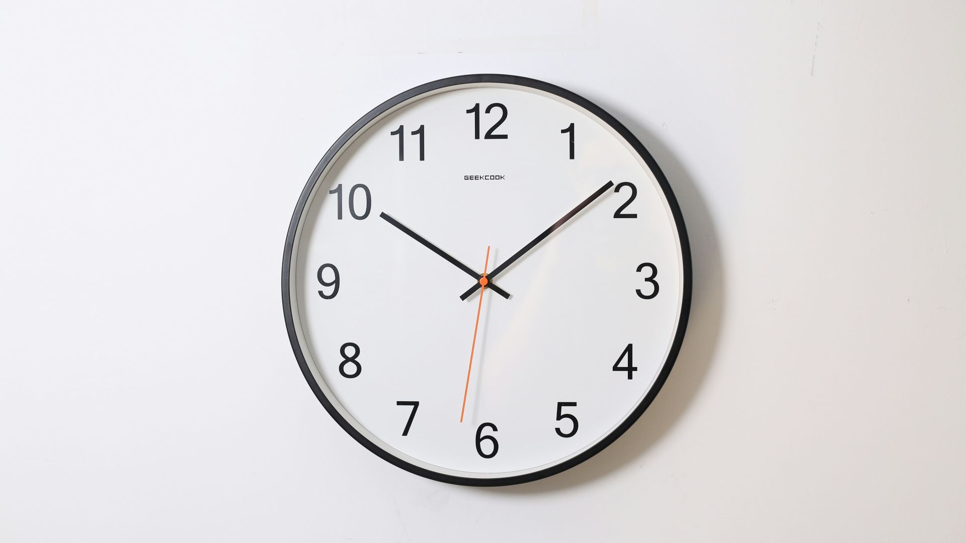 round analog wall clock pointing at 10:09