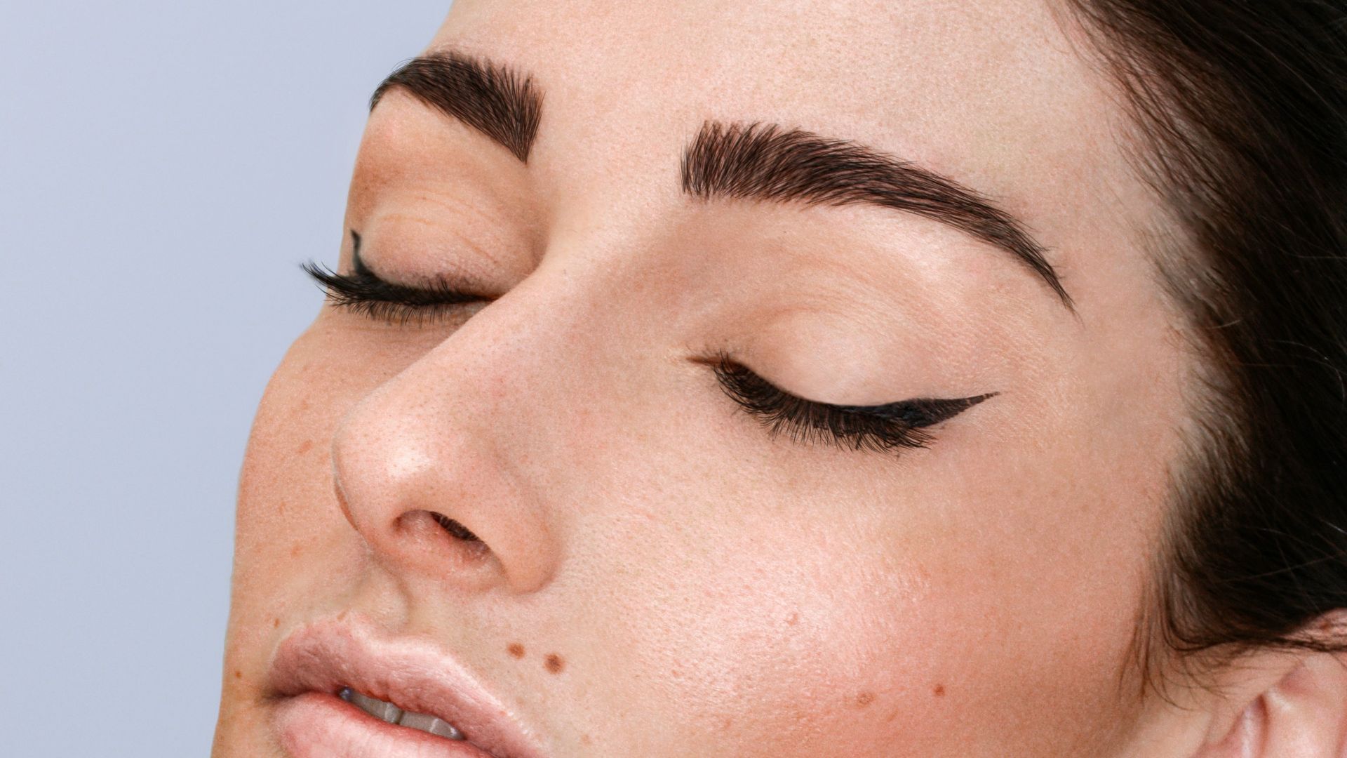 a woman with freckles on her face and neck