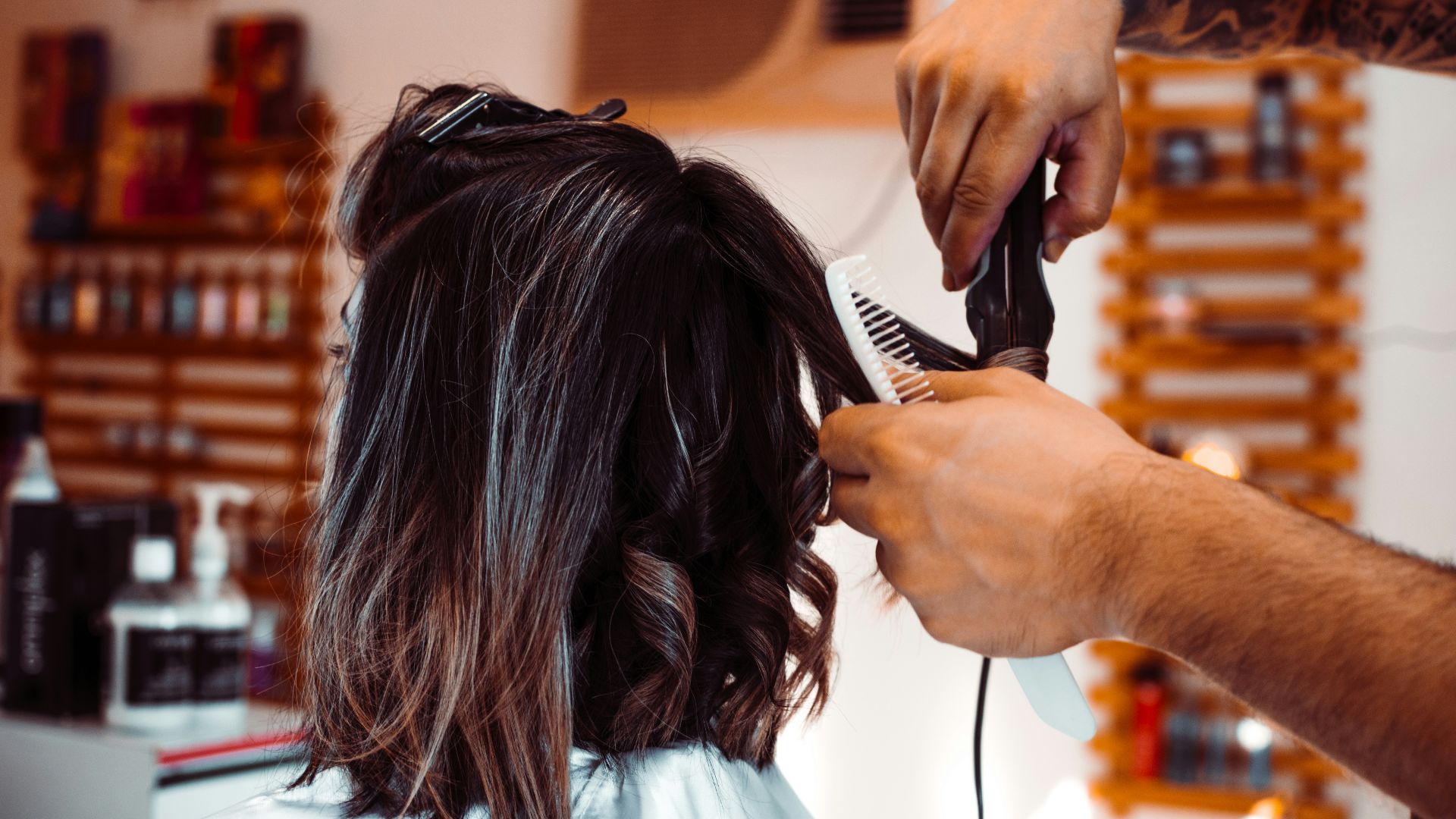 woman in white shirt holding hair blower