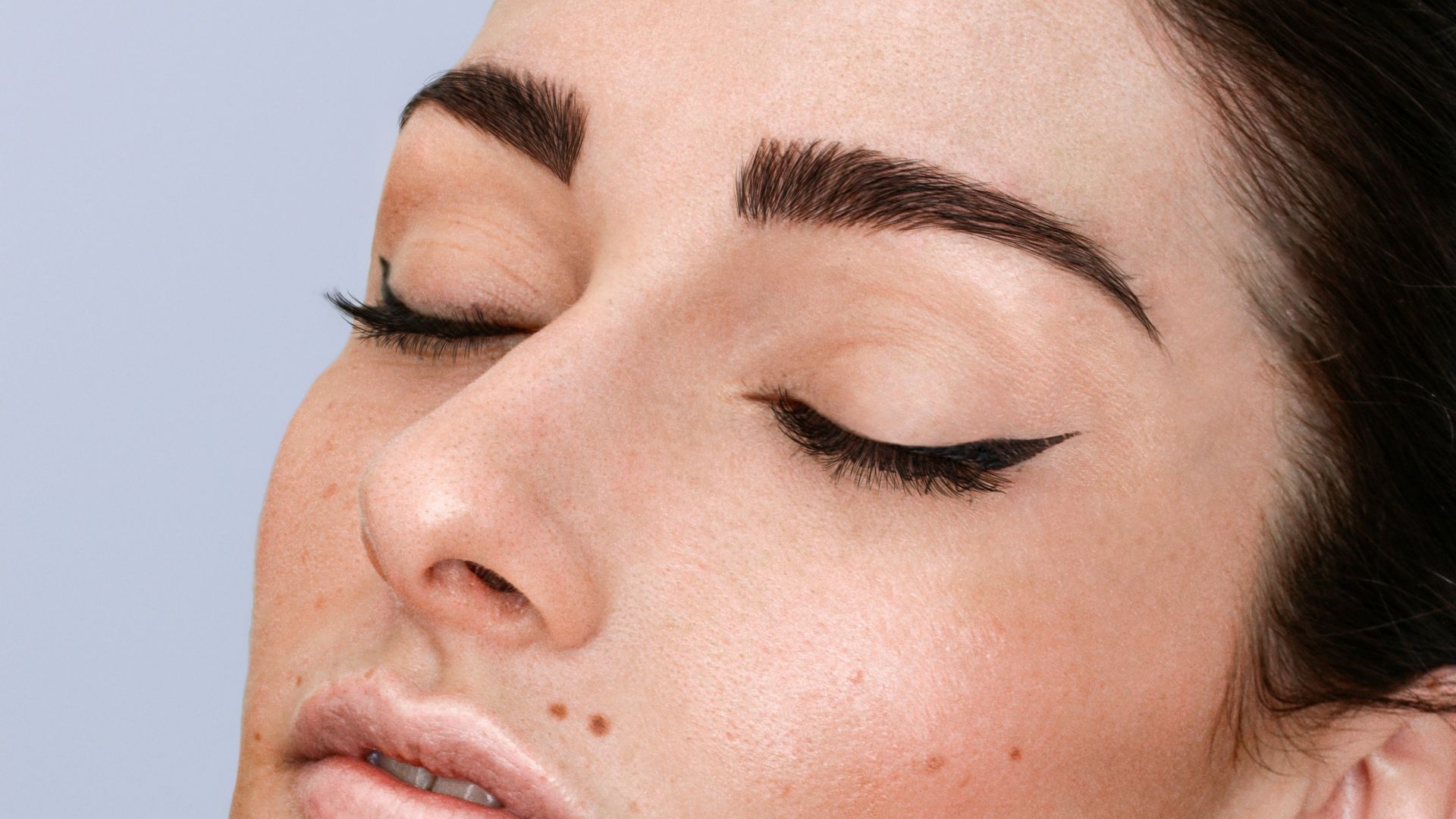 a woman with freckles on her face and neck