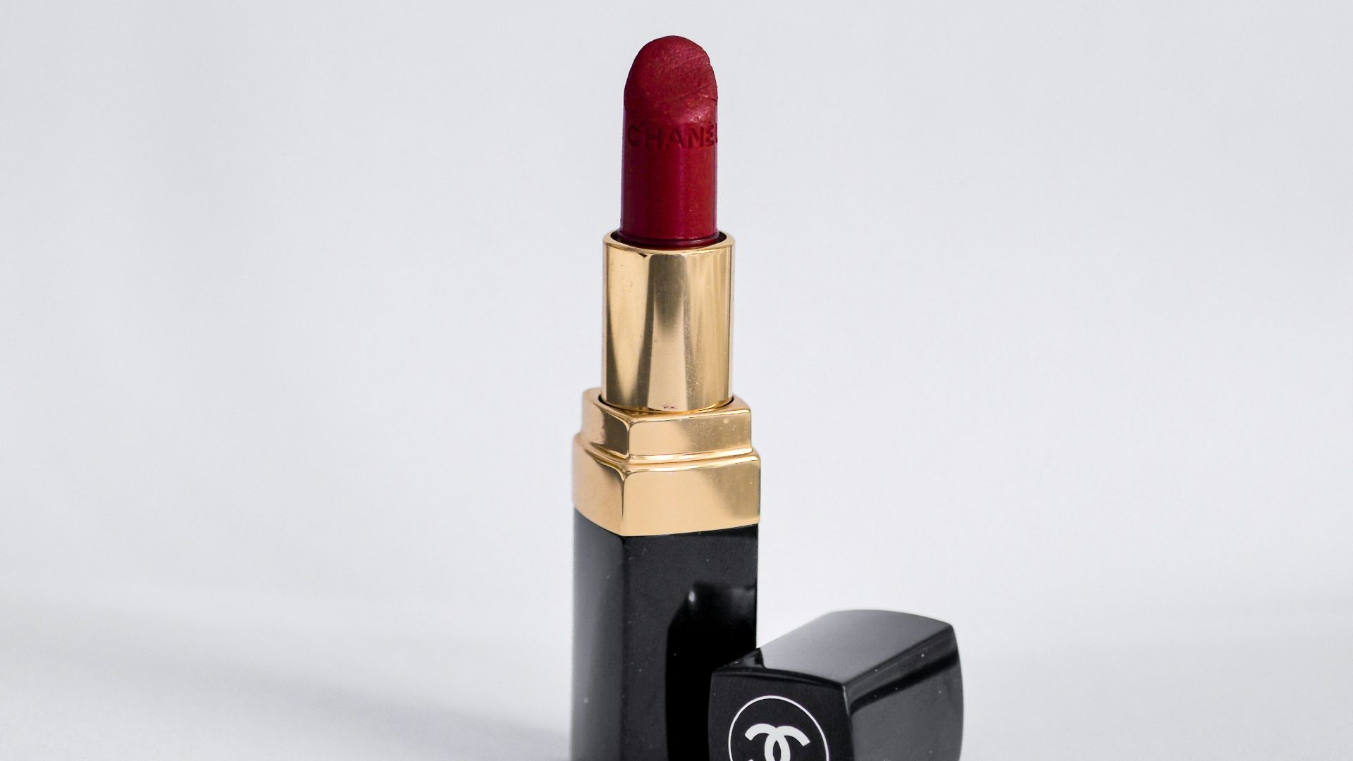 red lipstick on white surface