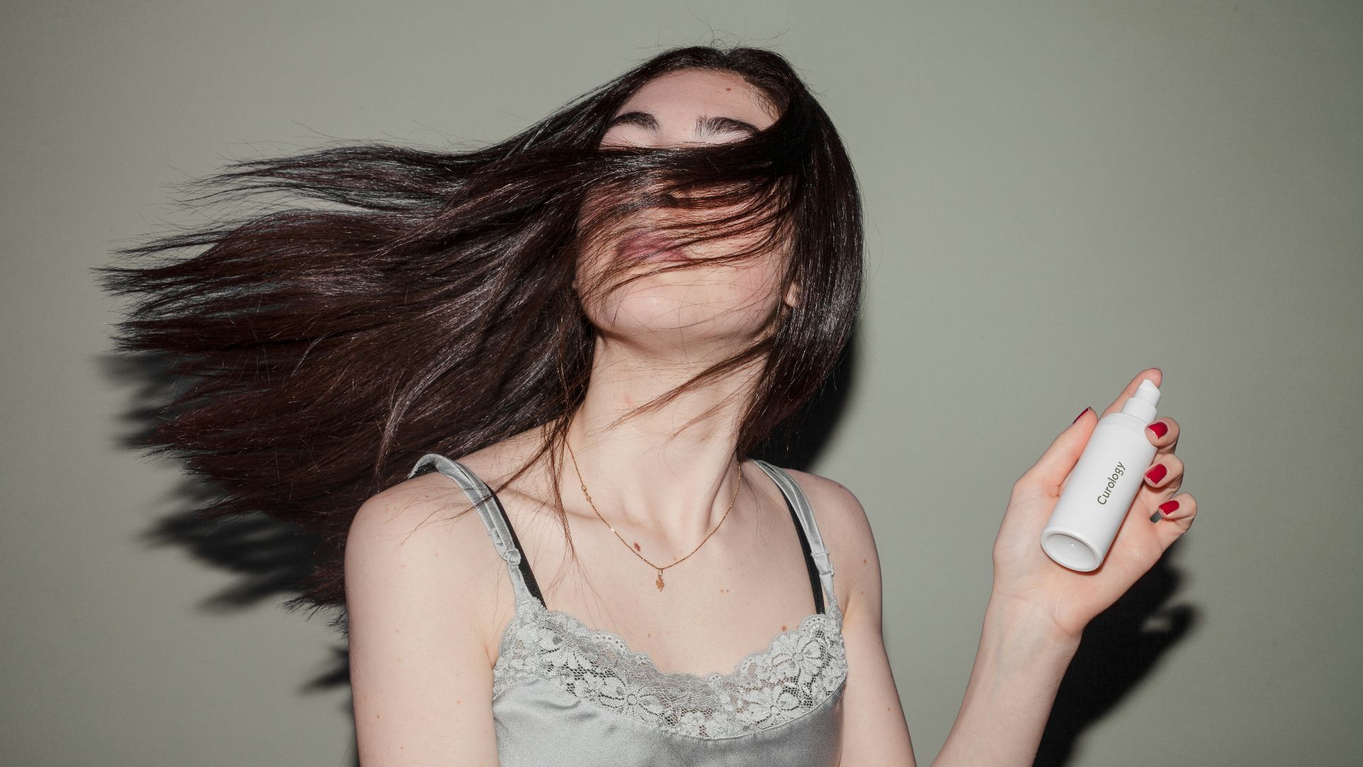 woman holding spray bottle