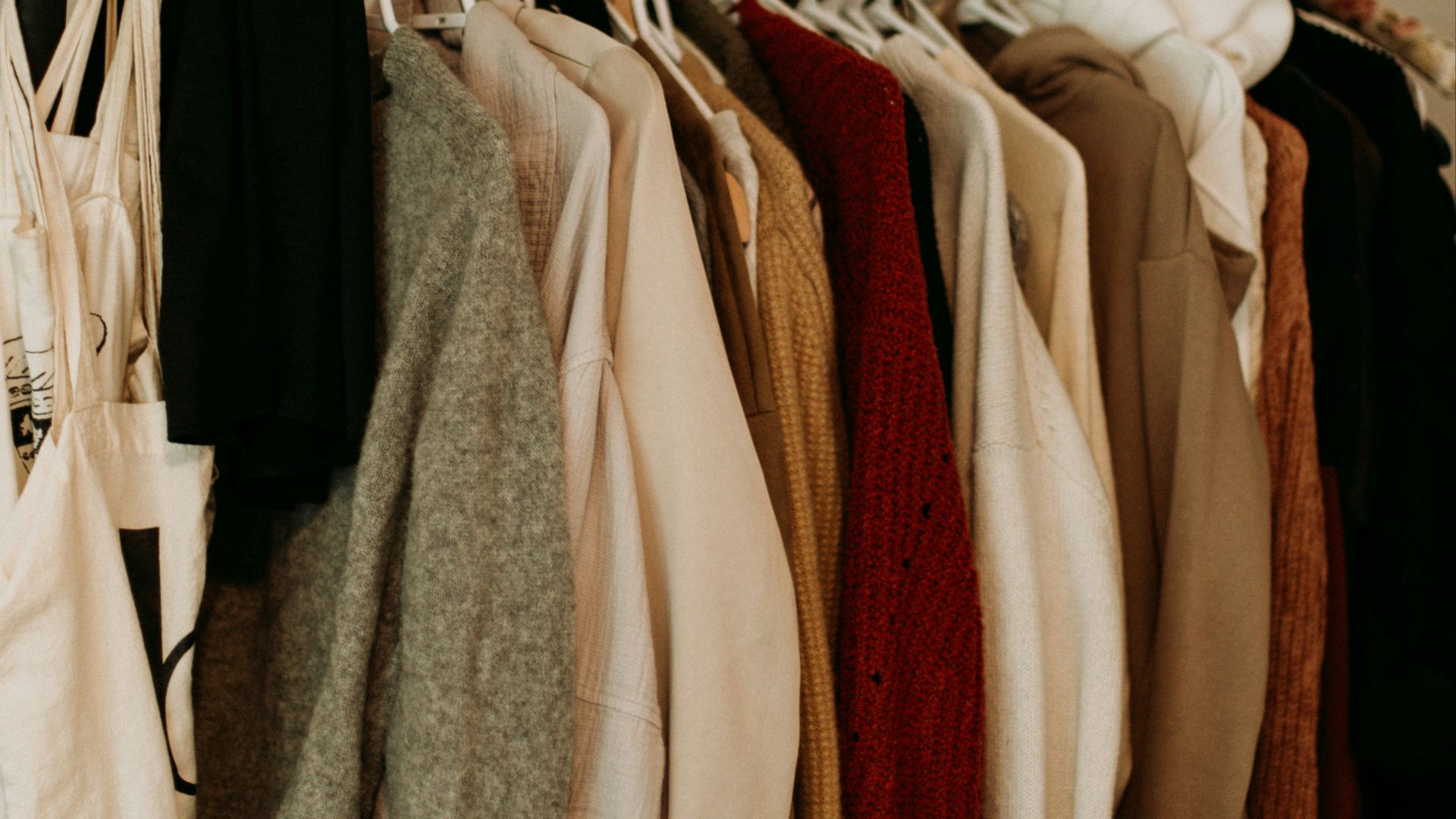 brown and white coat hanged on rack