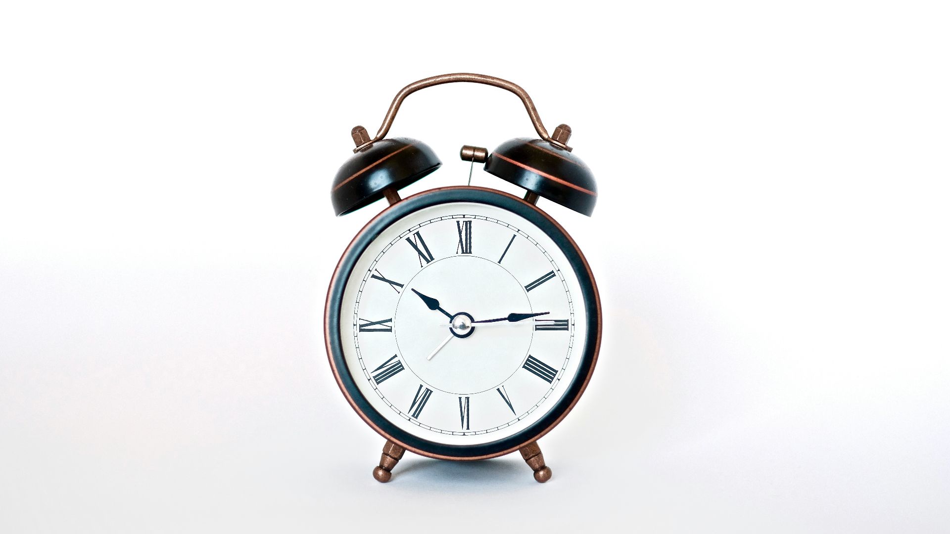 round black and white analog alarm clock