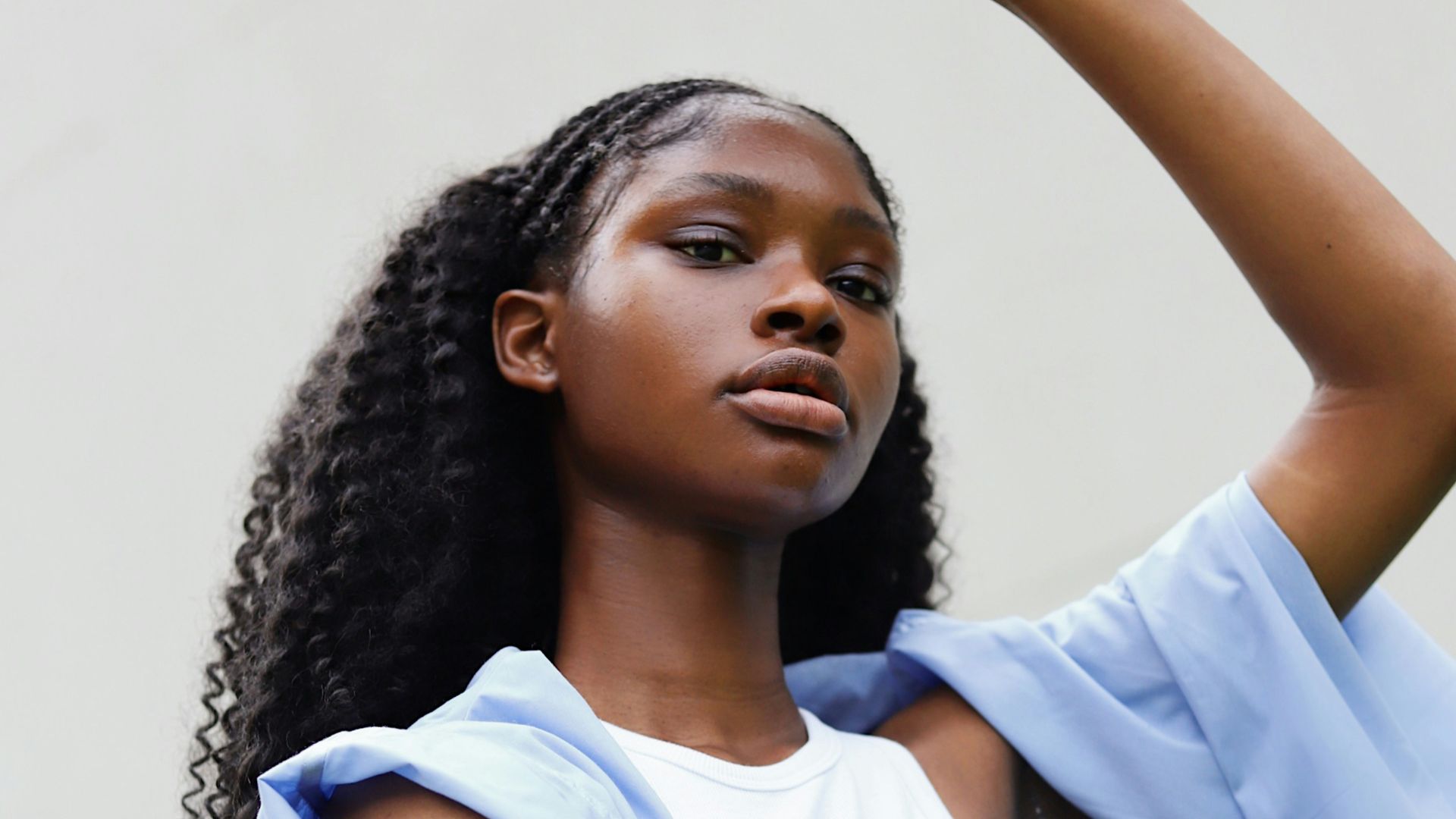 a woman in a white top and a blue jacket