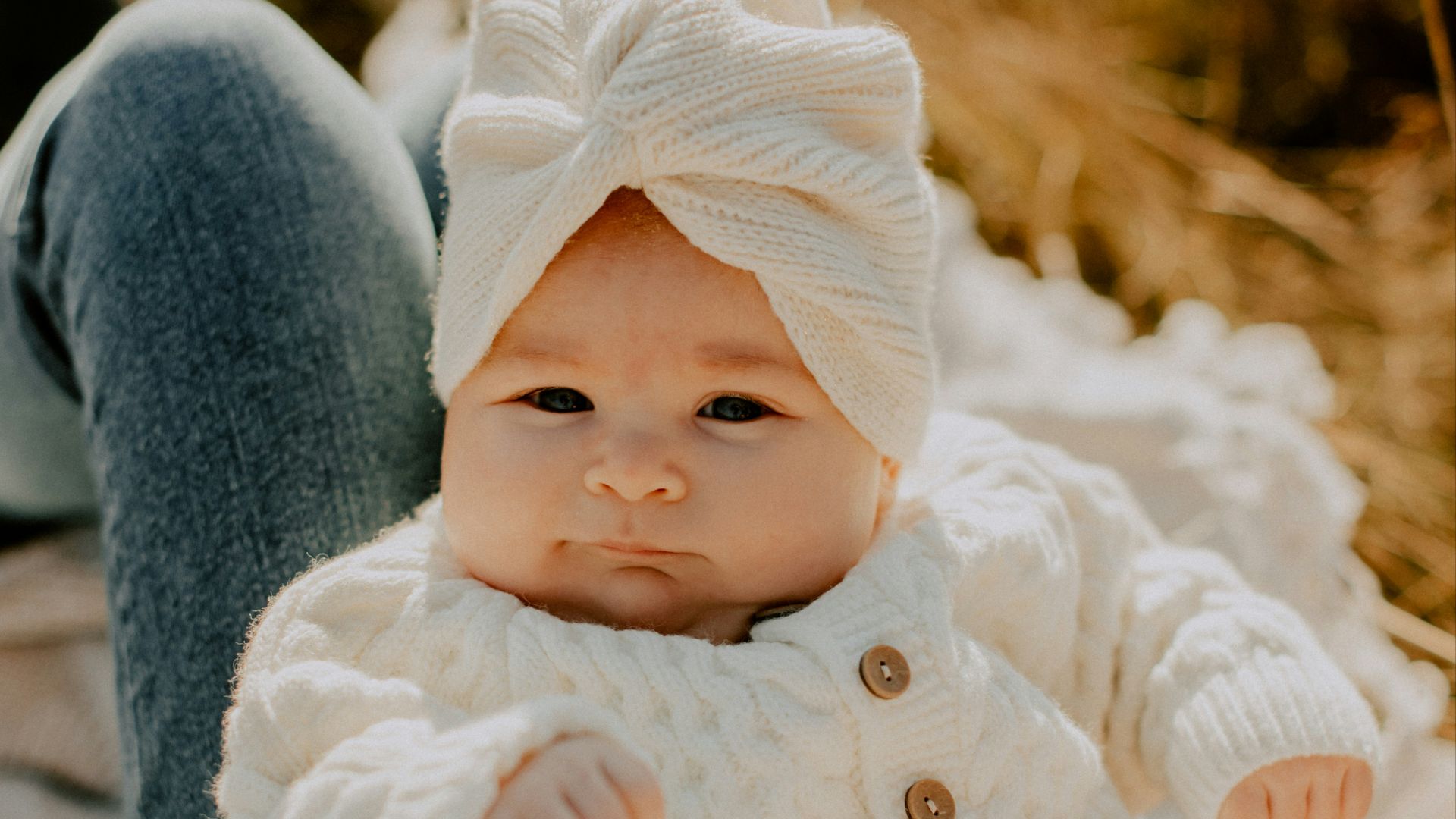 a close up of a baby holding a stuffed animal