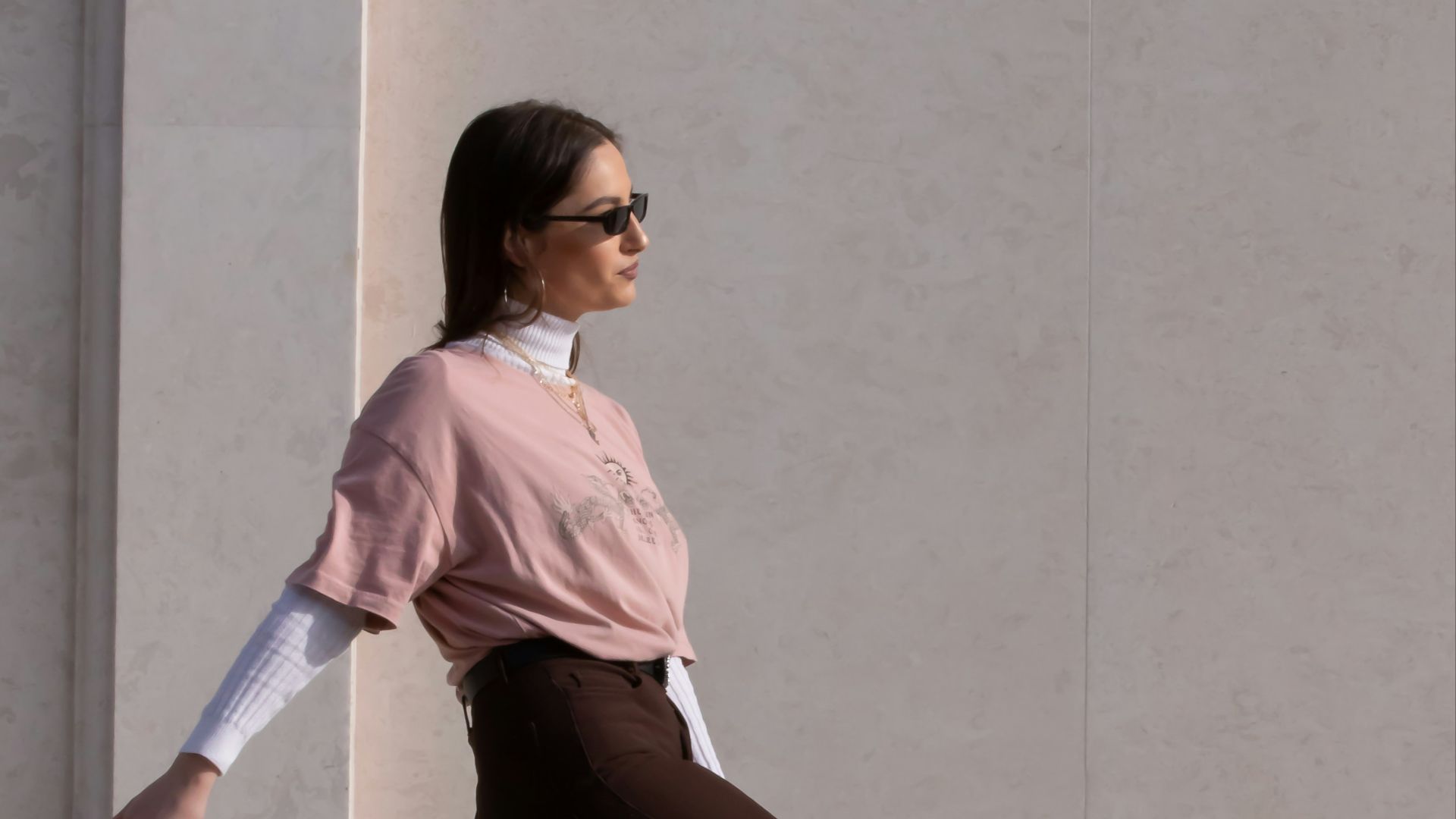 woman in pink shirt and black pants holding walking stick