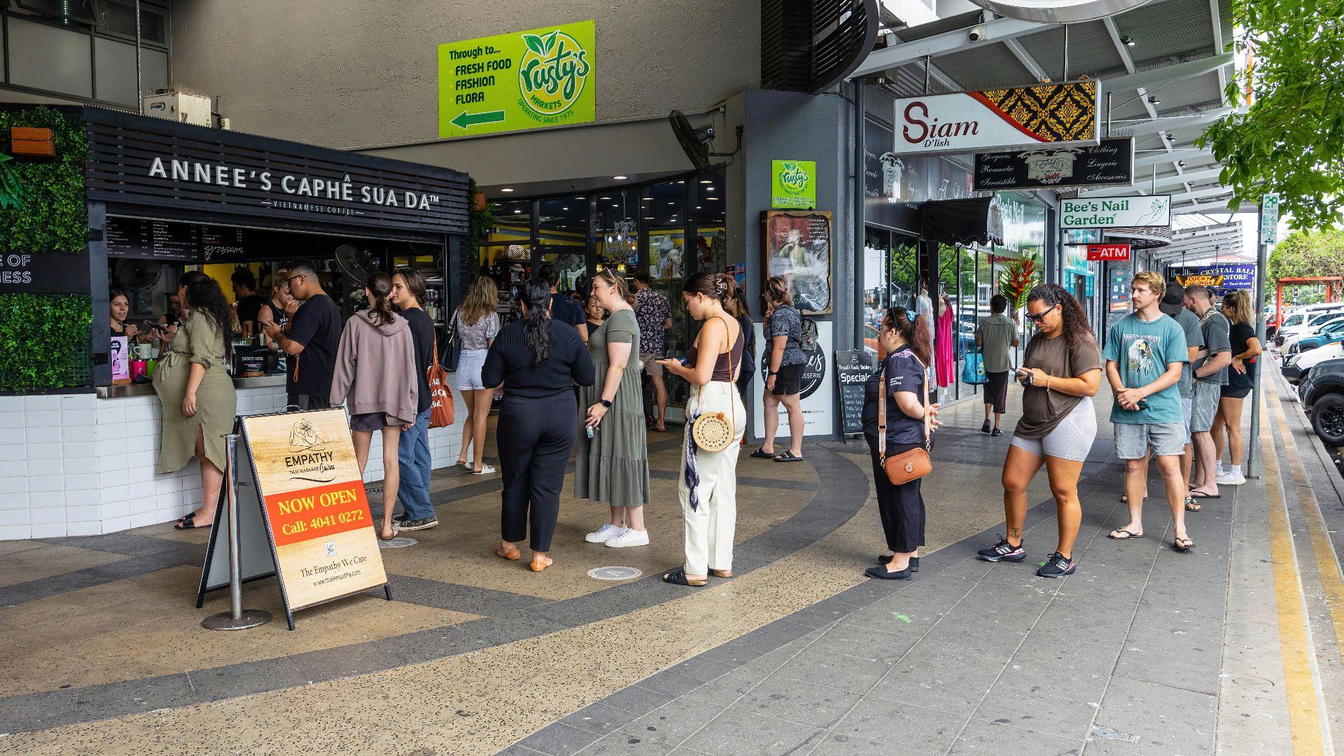 a group of people standing outside of a store