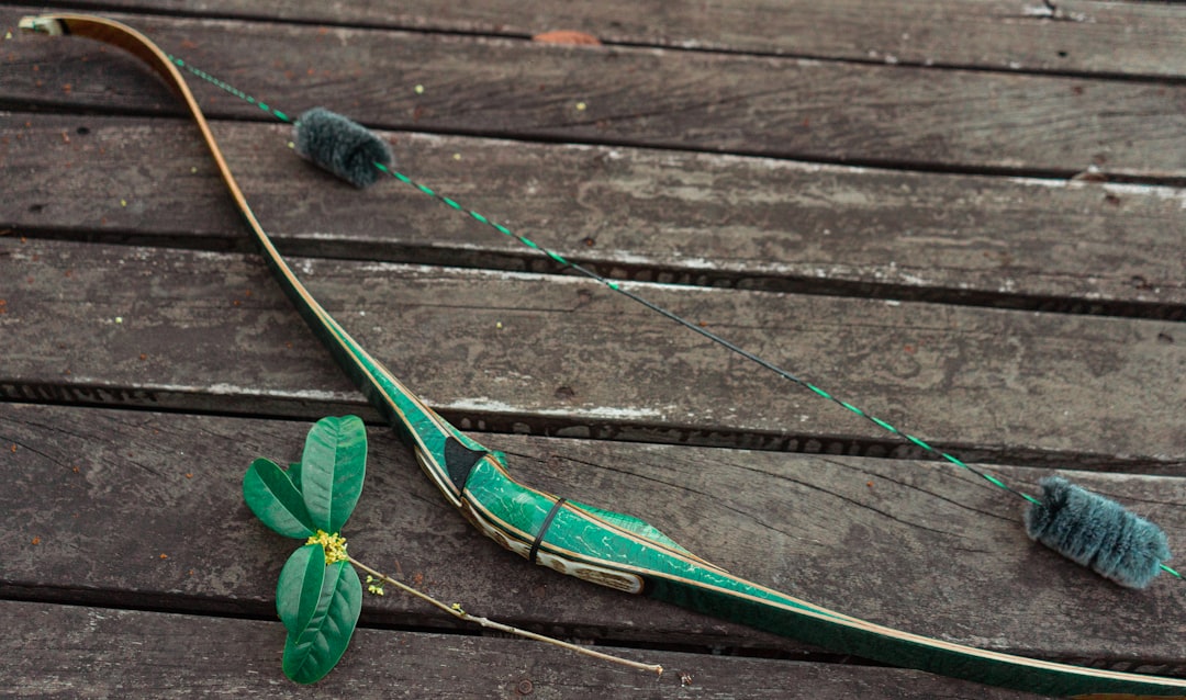 a green snake on a wooden surface
