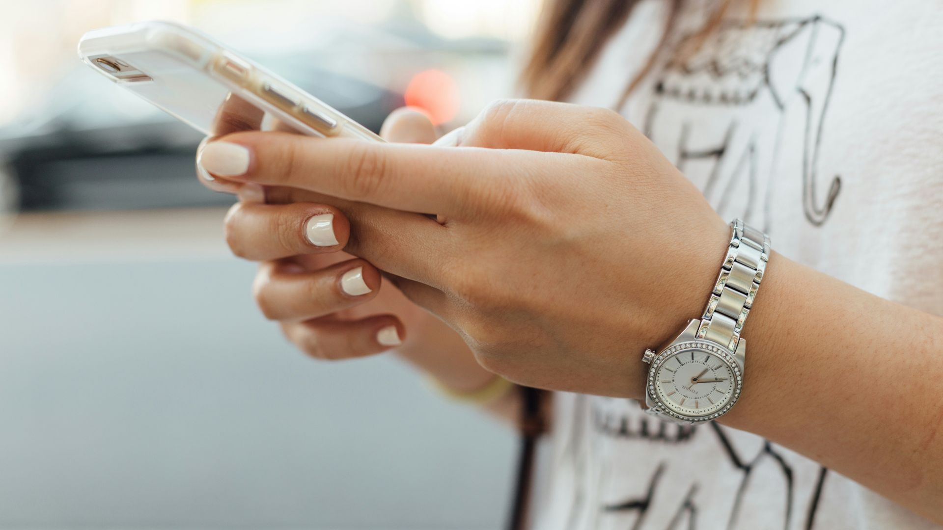 woman holding iPhone during daytime