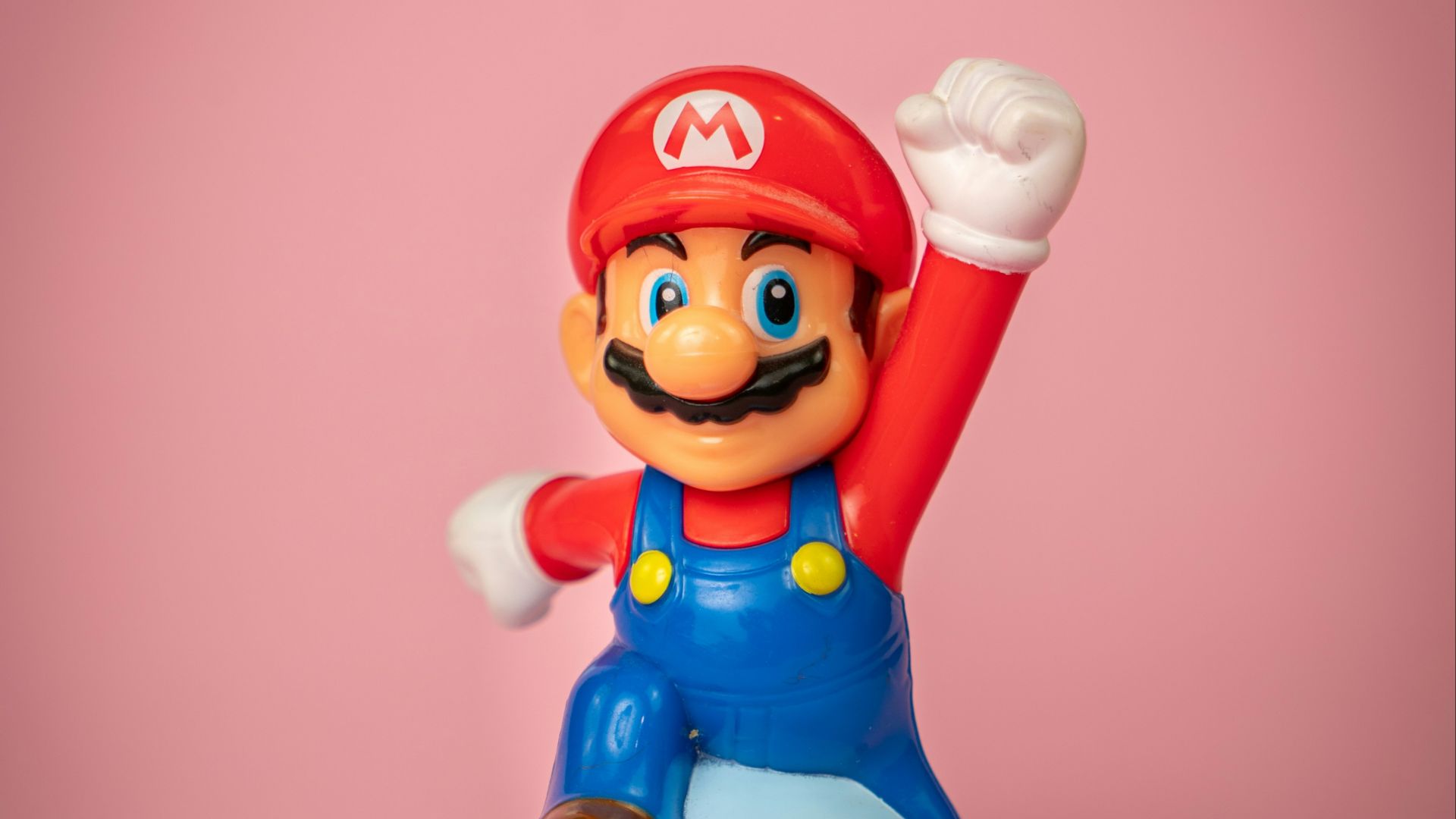 a toy figure of mario on top of a blue object