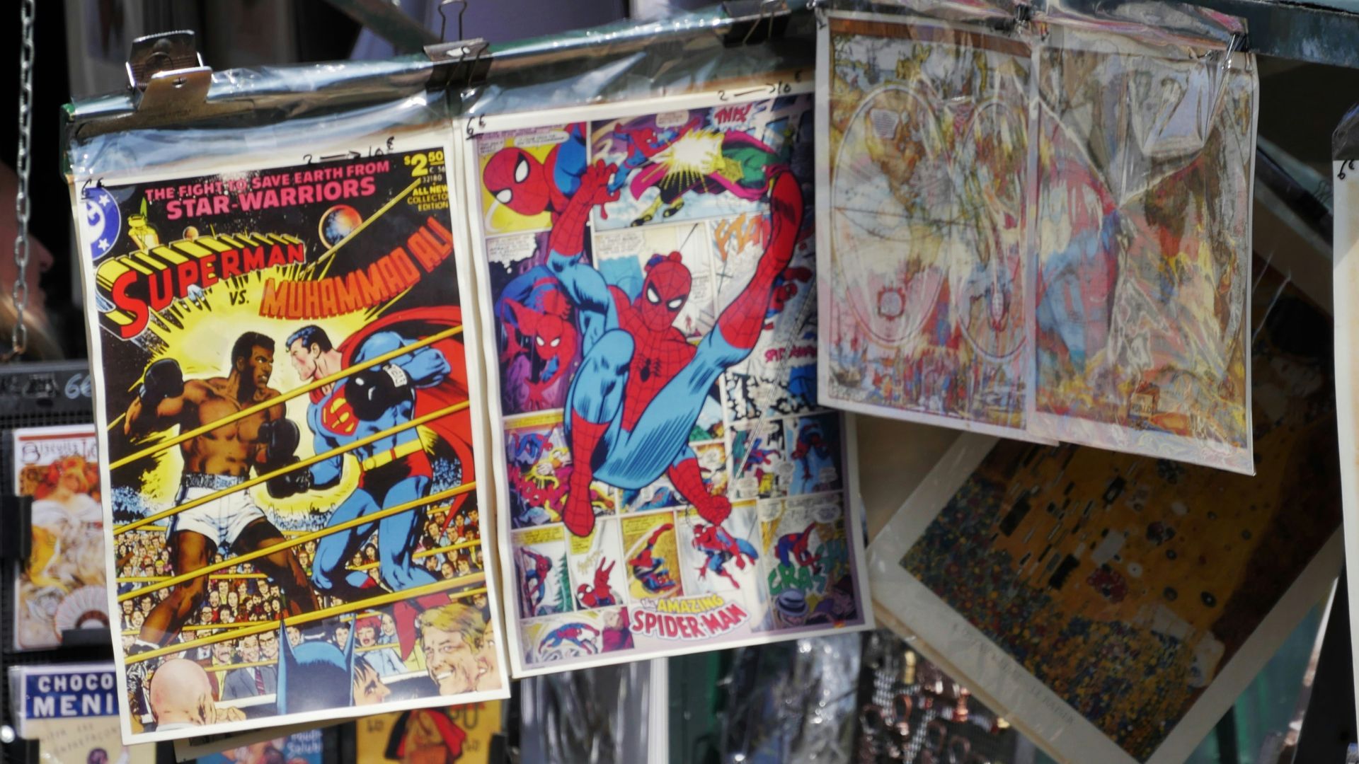 man in black t-shirt standing beside white and blue umbrella