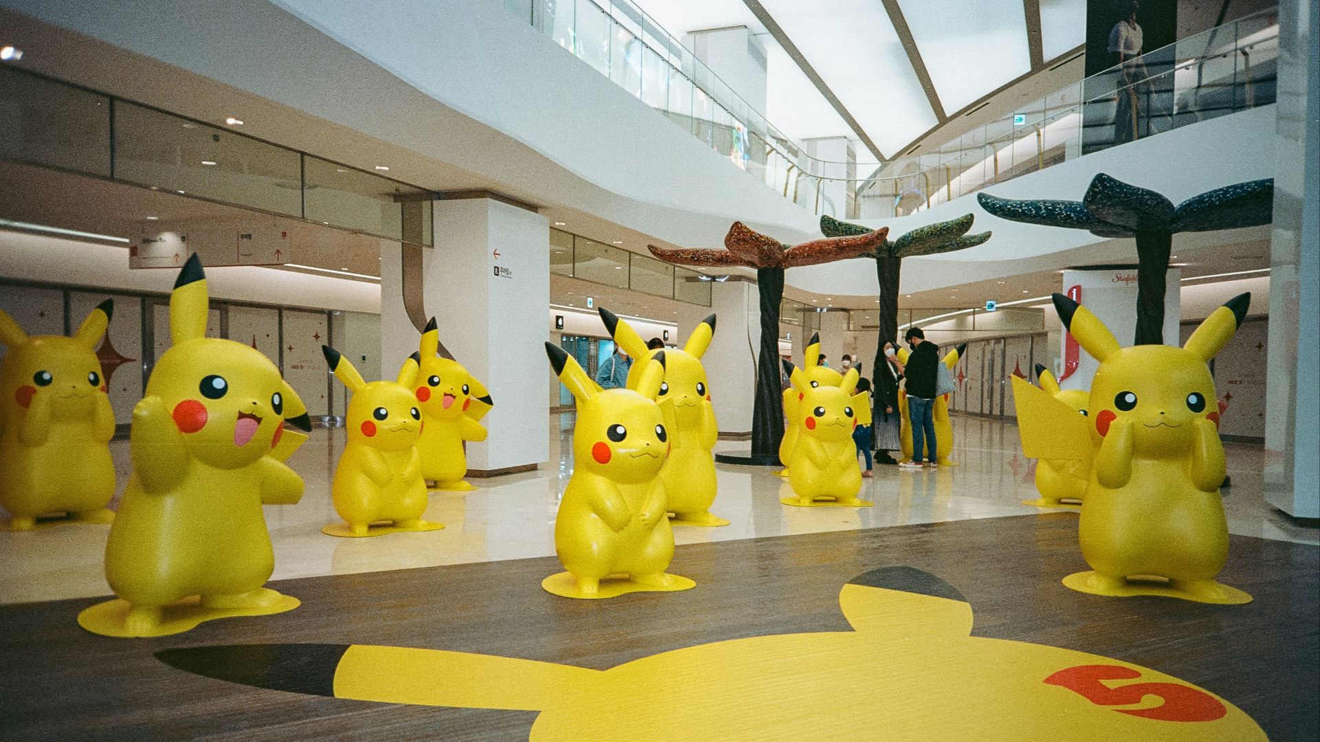 a group of pikachu statues in a building
