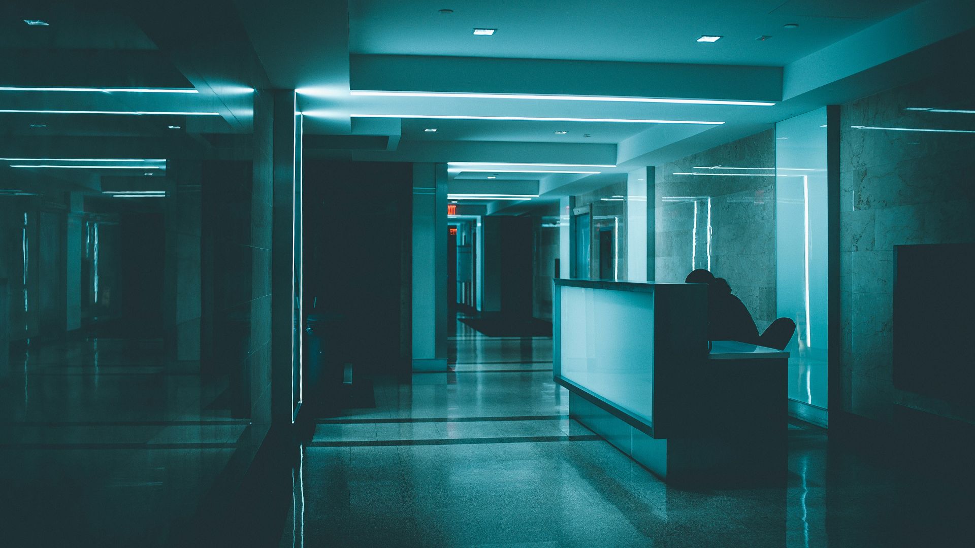 white wooden desk on hallway inside building