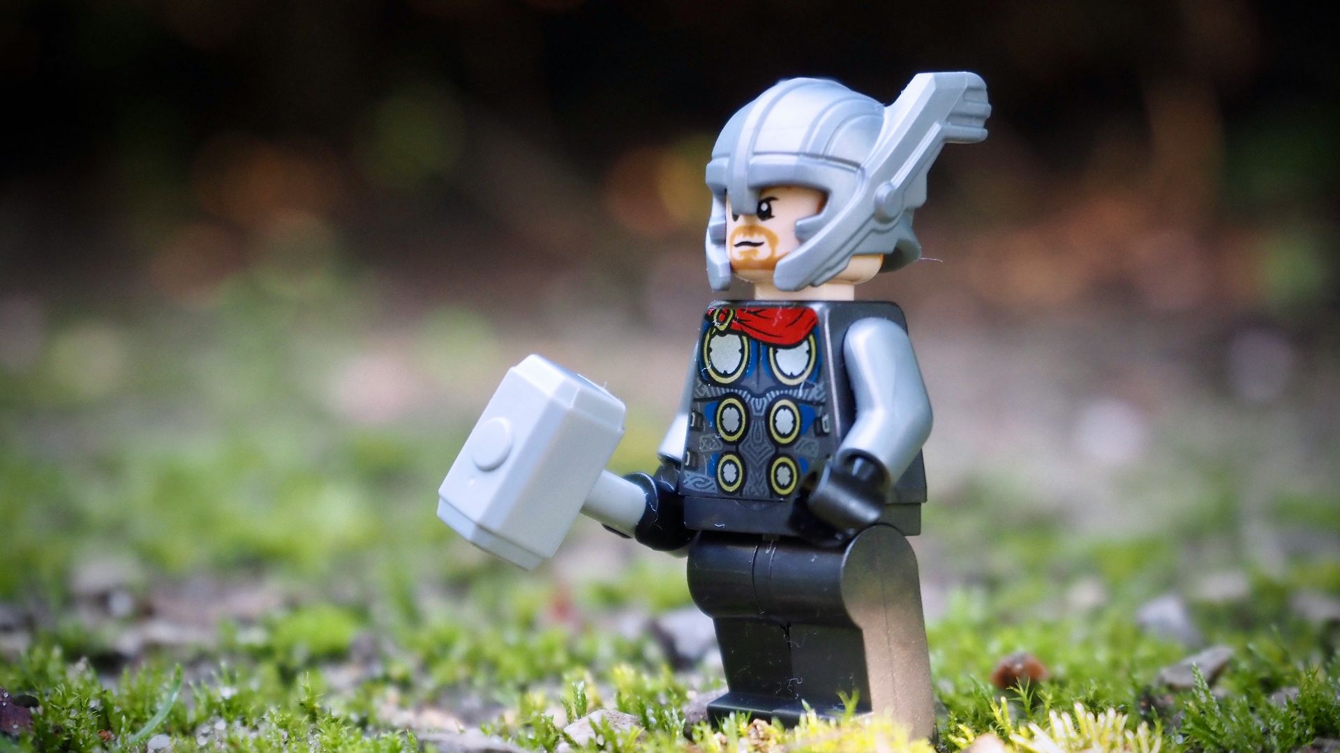 lego minifig on green grass during daytime