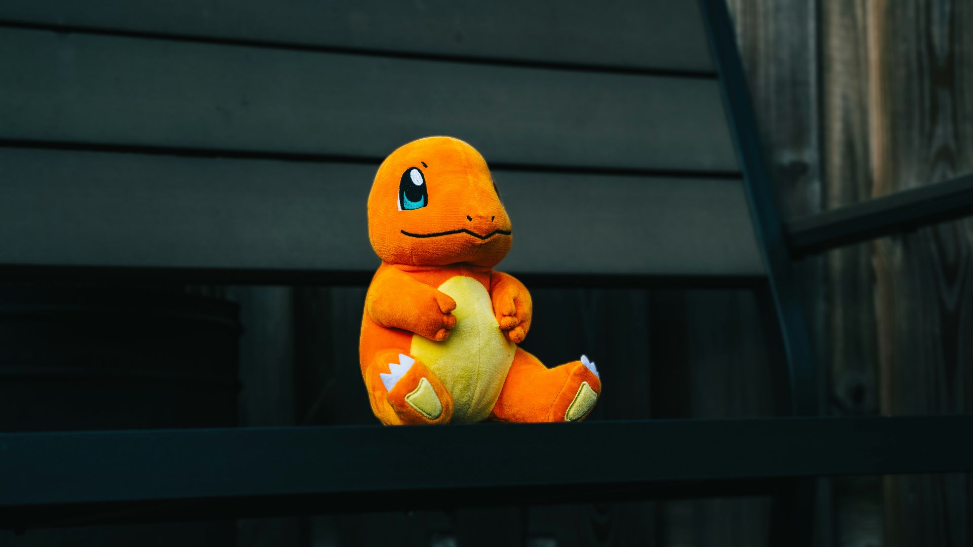 a stuffed toy sitting on top of a wooden bench