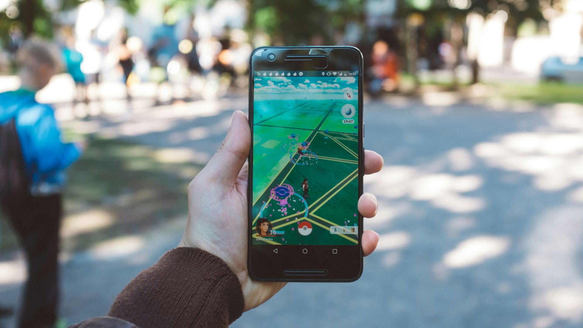 person playing Pokemon Go during daytime