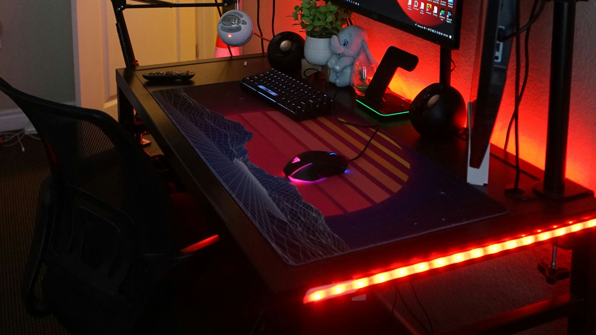 a computer desk with two monitors and a keyboard