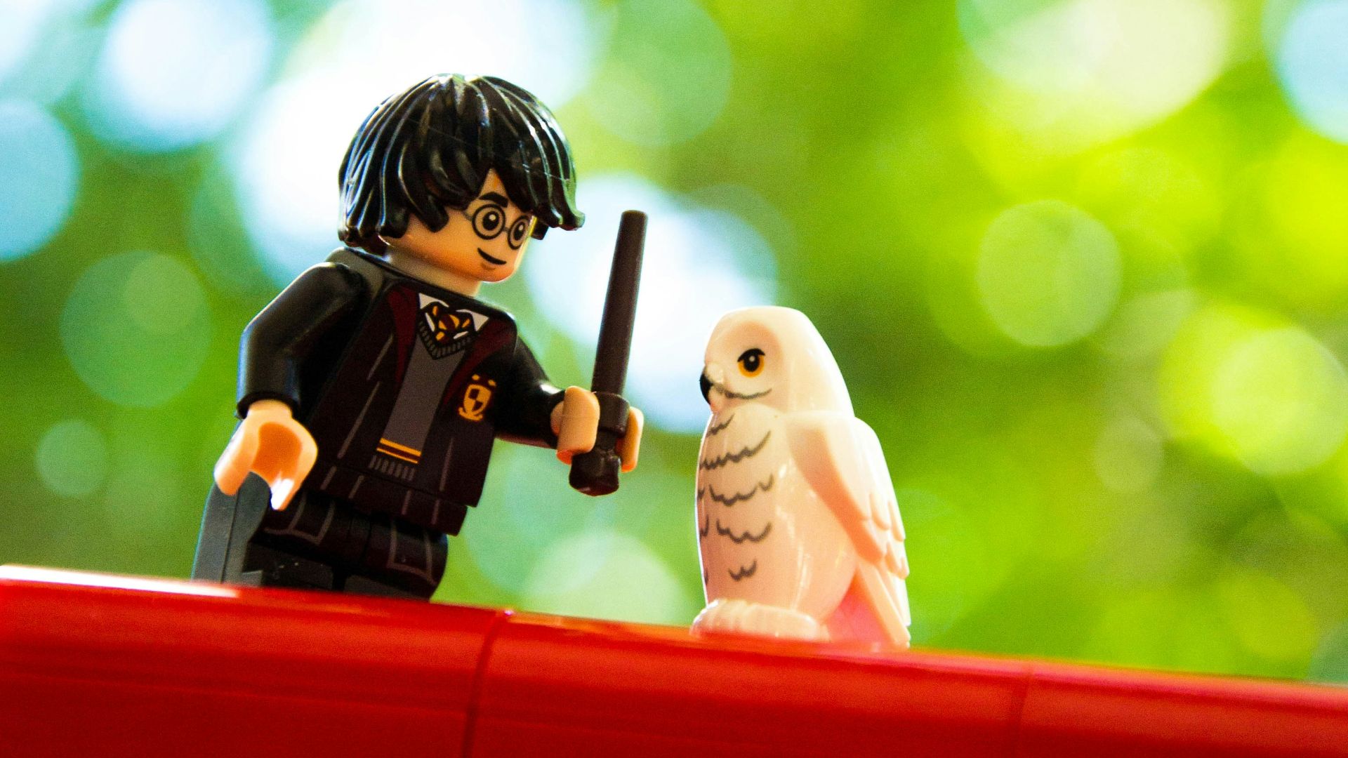 boy in black and white long sleeve shirt holding black and red camera figurine